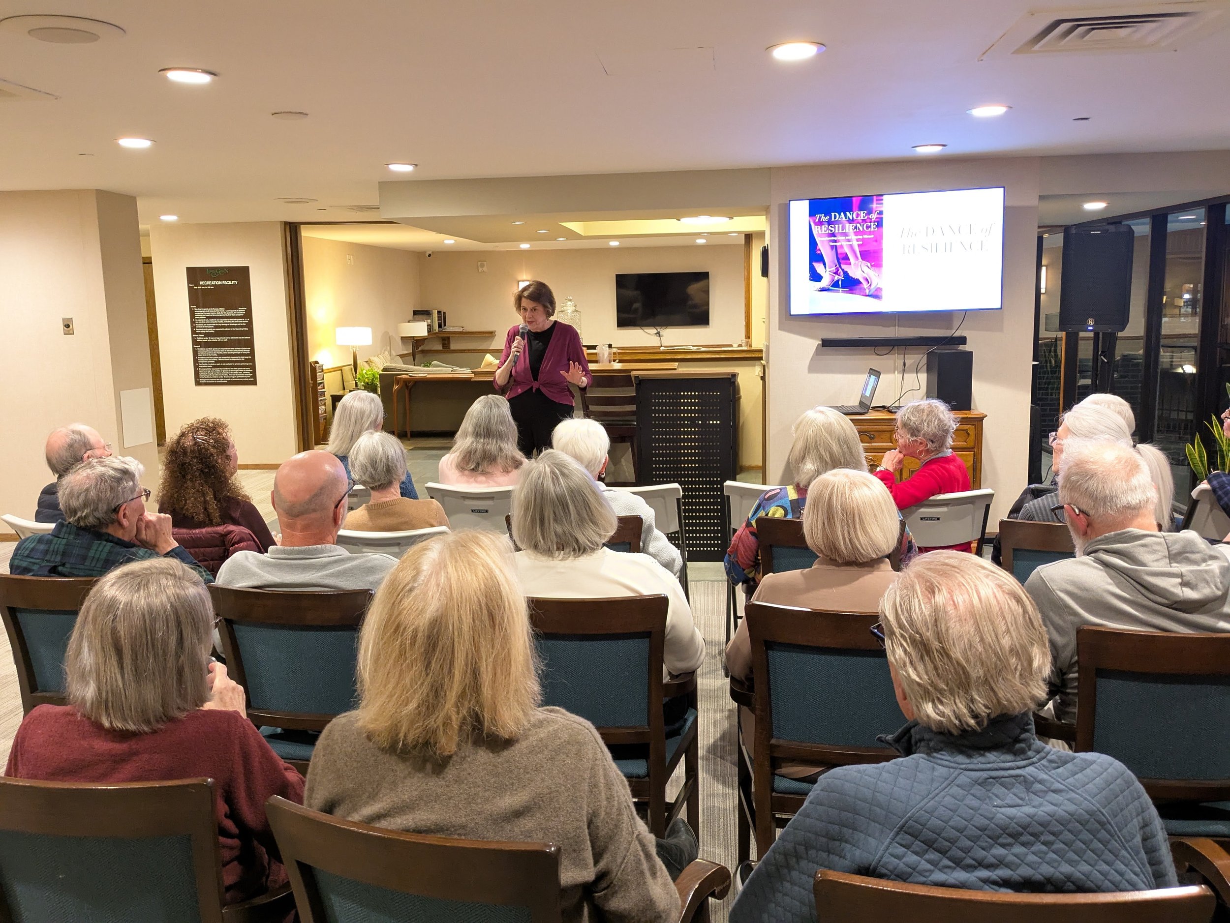 Ember gives a book talk to a full room at Loring Green West.