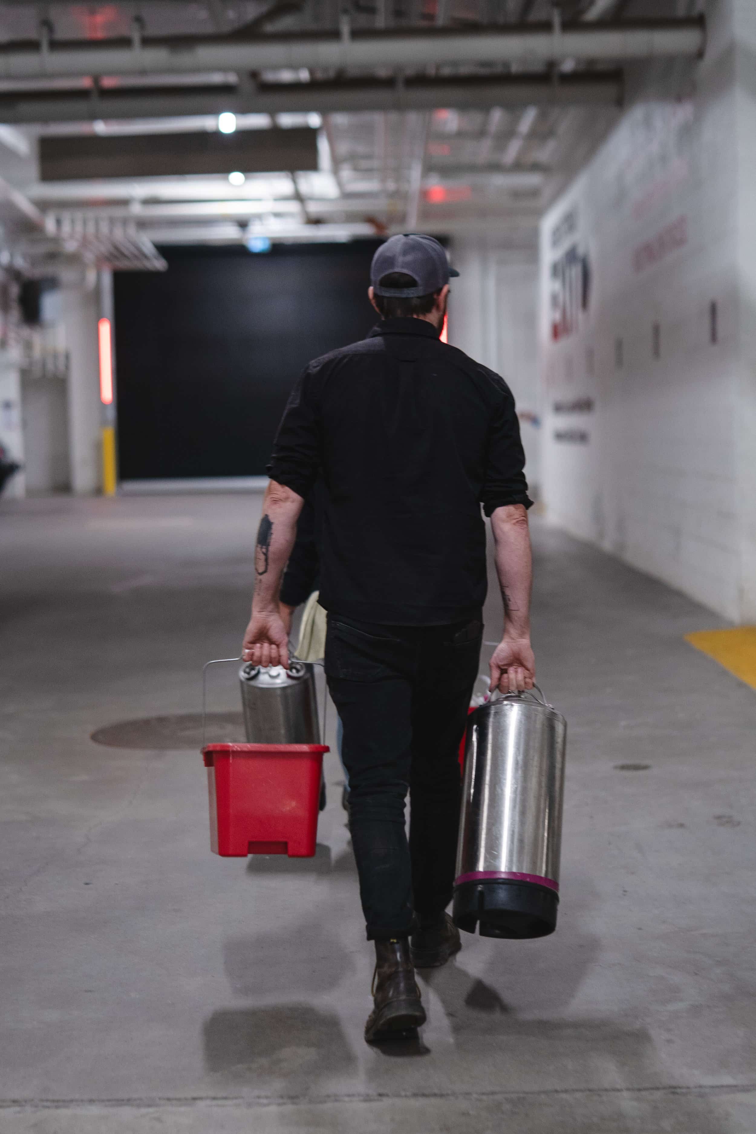 One of technicians walking to a service job, carrying tools.