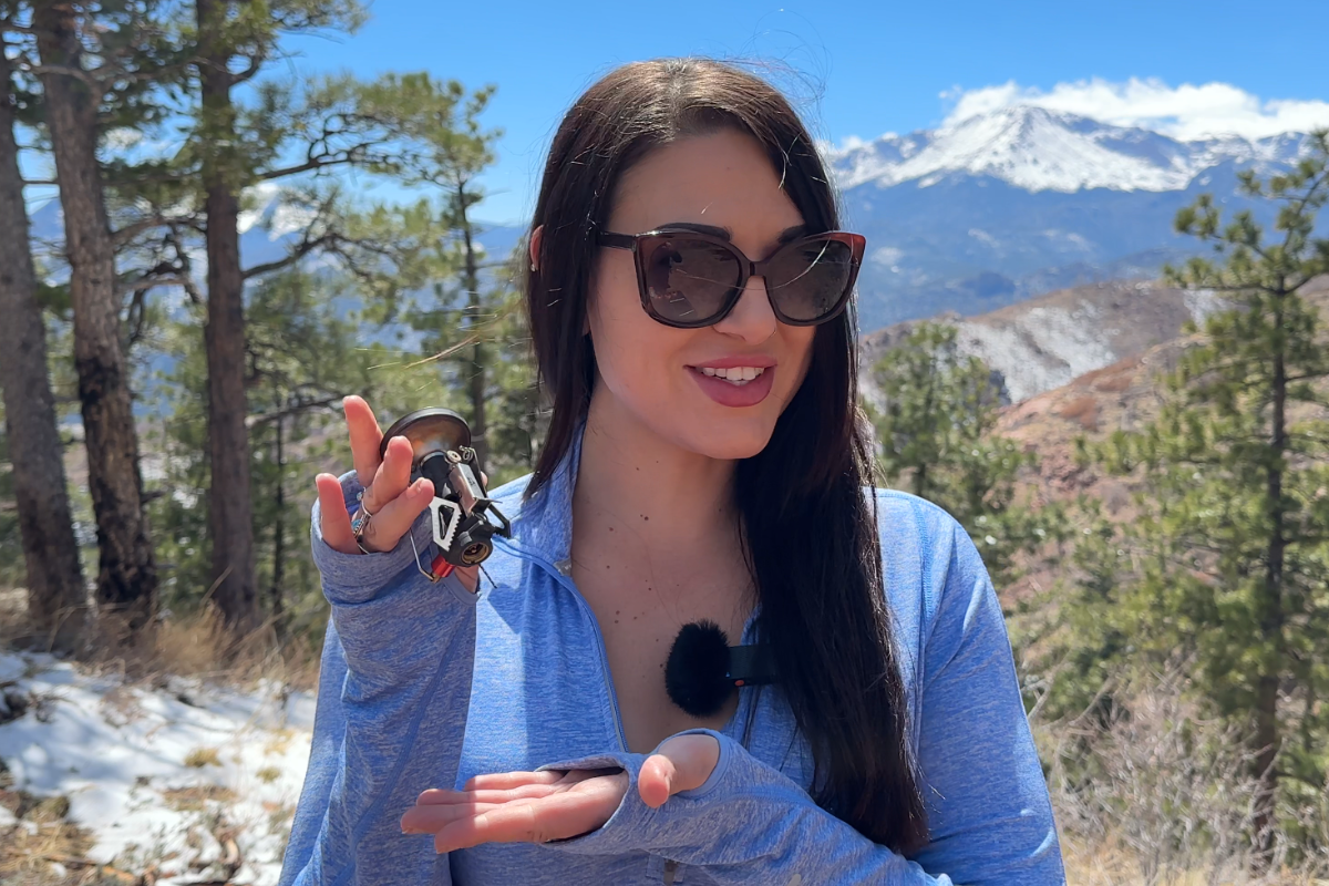 Beautiful woman holding the MSR Pocketrocket Deluxe backpacking stove