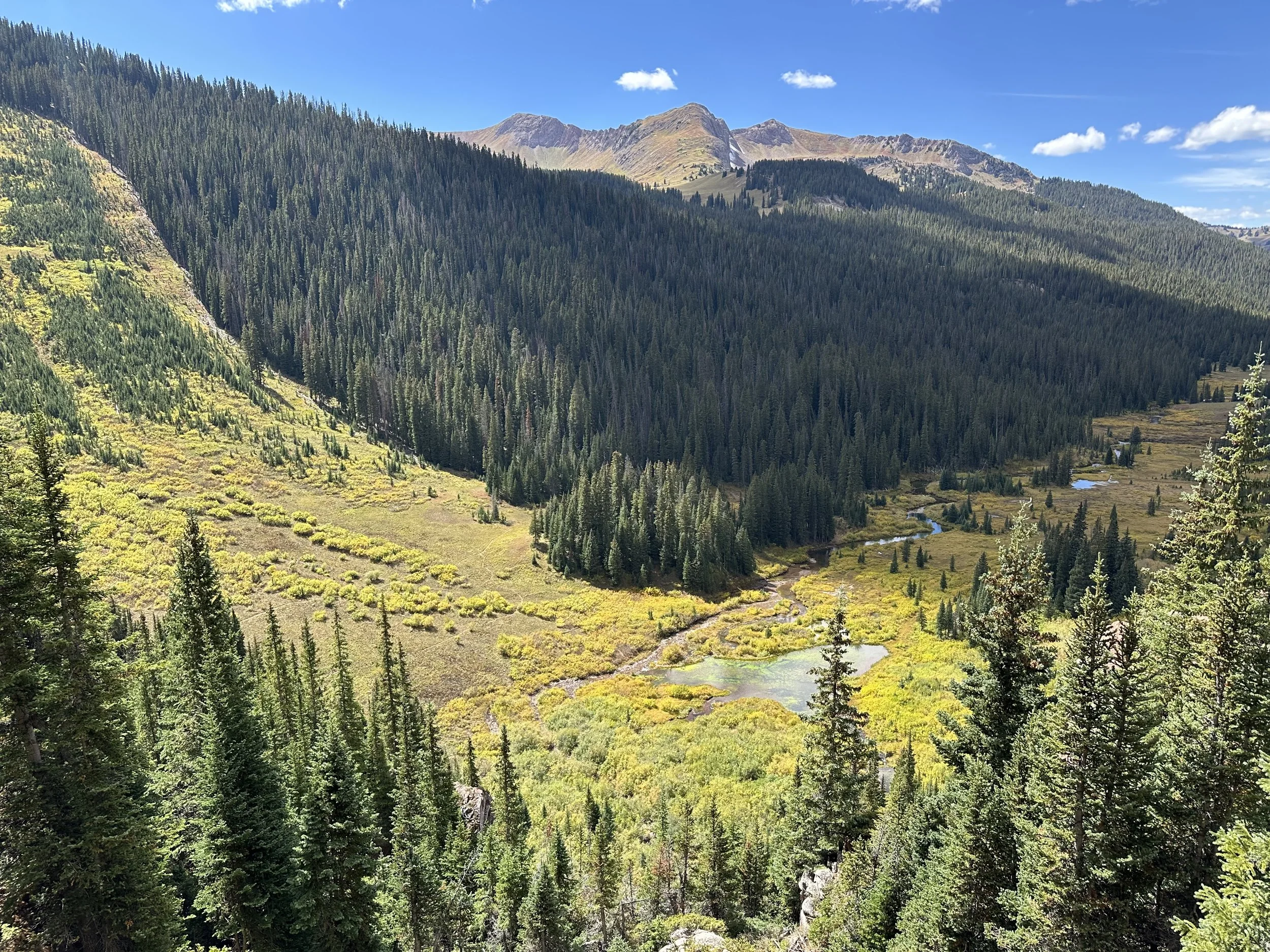 Beautiful valley with a river running through it along the Four Pass Loop