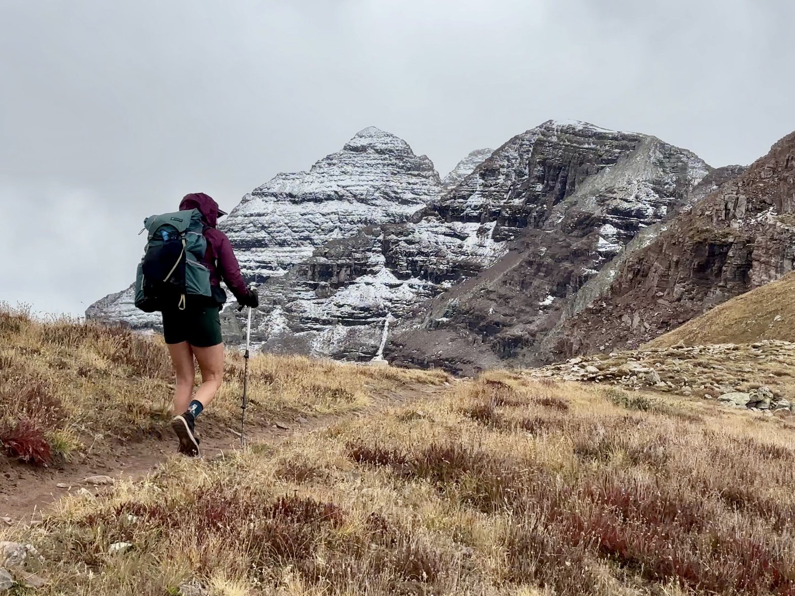 Beautiful hiker on Buckskin pass along the Four Pass Loop in front of the Maroon Bells