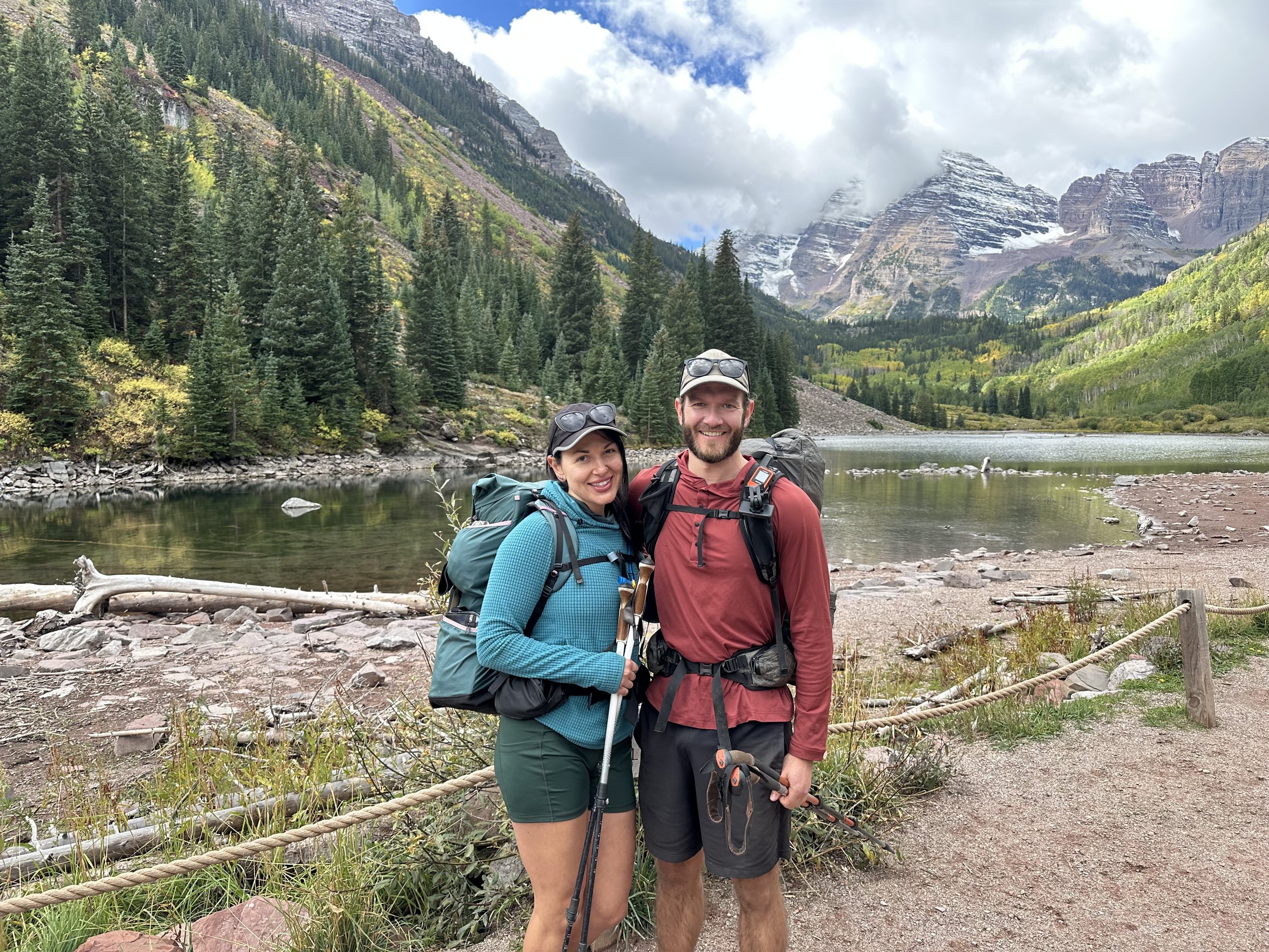 Two backpackers in front of the Maroon Bells in Colorado