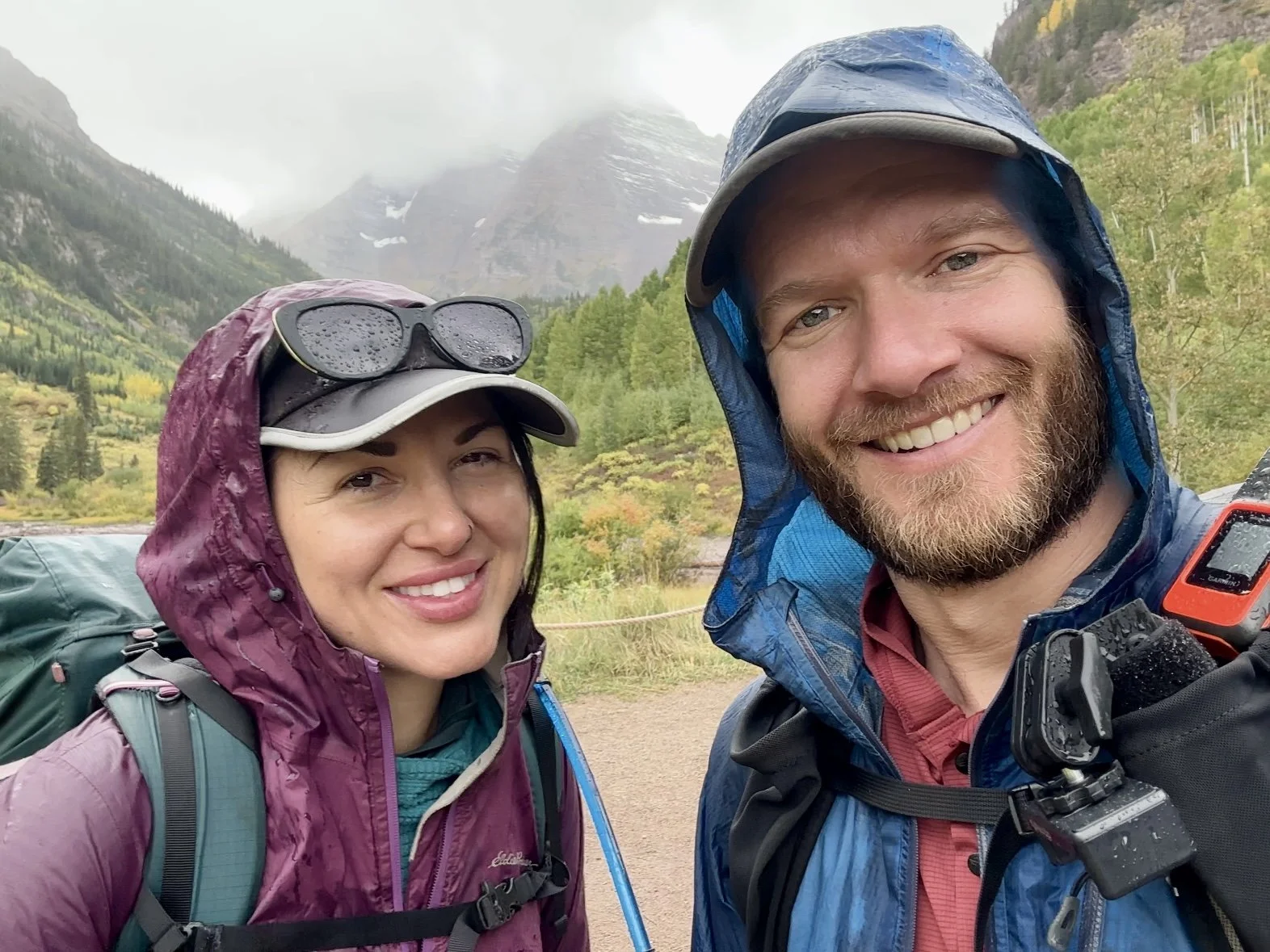 Two backpackers finishing the Four Pass Loop in the rain