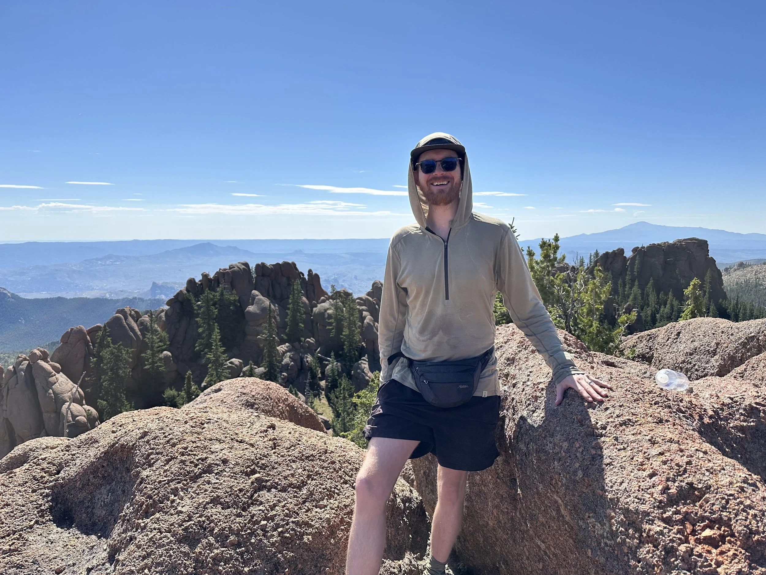 Hiker on a rock outcropping with sweeping views of the lost creek wilderness