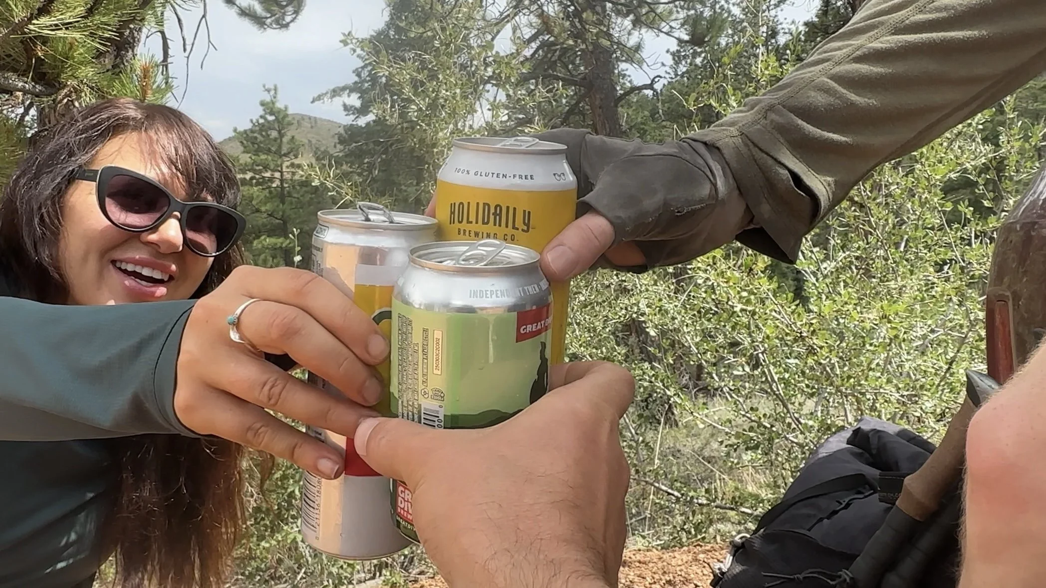 Hikers celebrating with beer and drinks after a hike