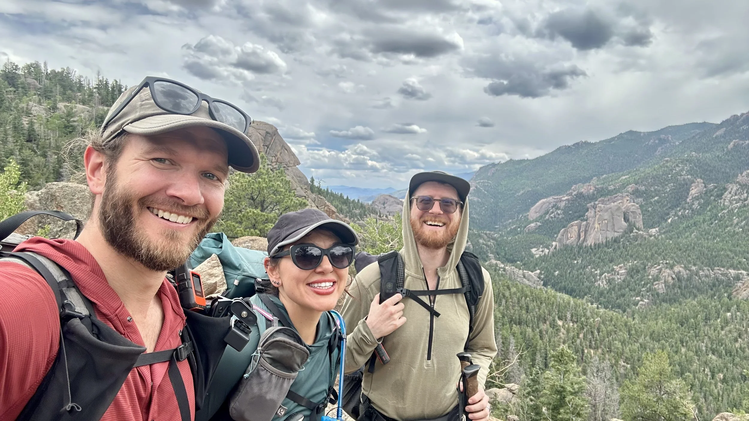 Three happy hikers enjoying being outside in the mountains