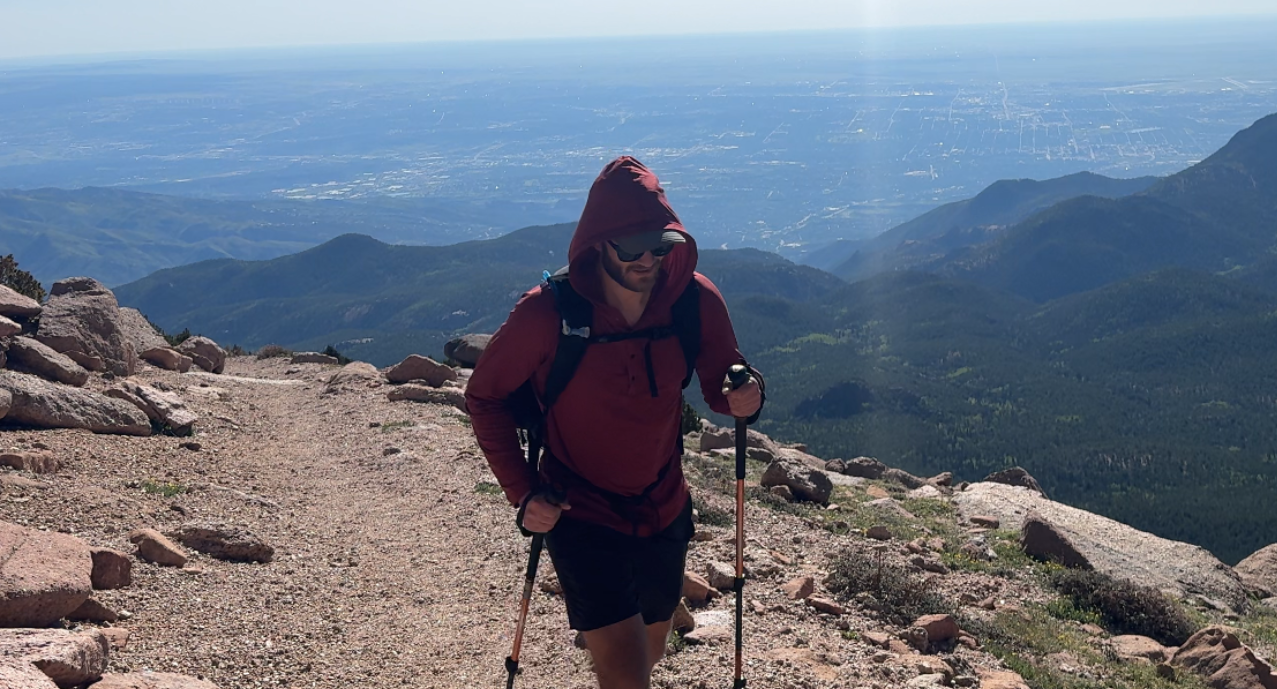 Hiker on Pikes Peak in the sun wearing the Ketl Mountain Nofry Sun Hoodie