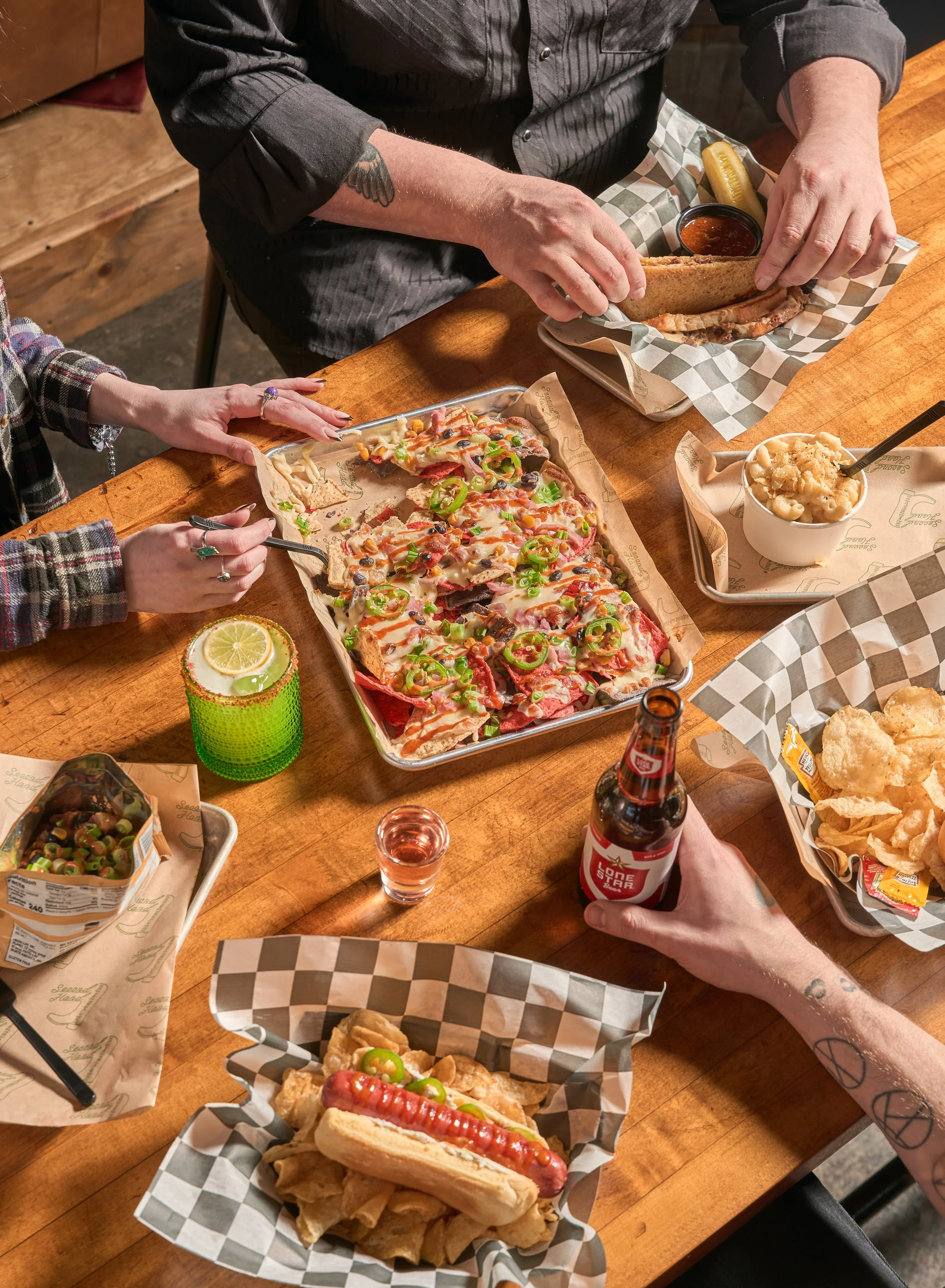 image of hands eating nachos and drinking margaritas
