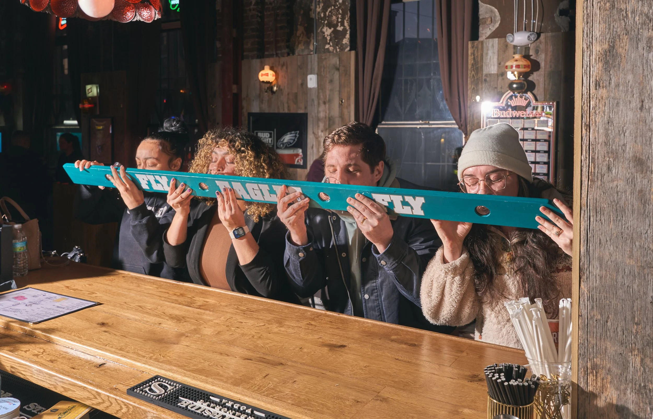 Group of friends at a party, and doing a shotski