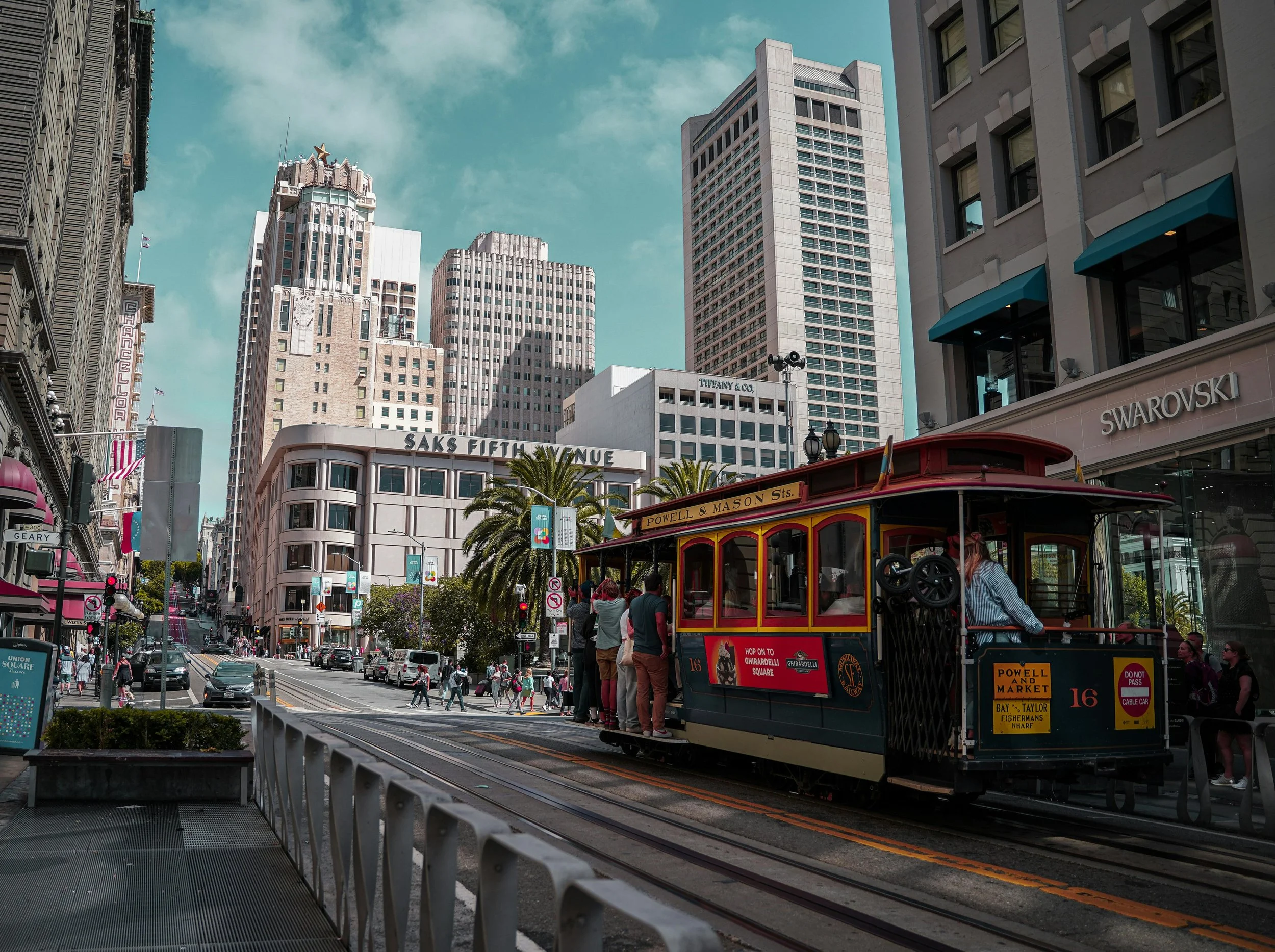 Photo of a street car traveling on Powell St. toward Union Square in San Francisco, buildings in the background