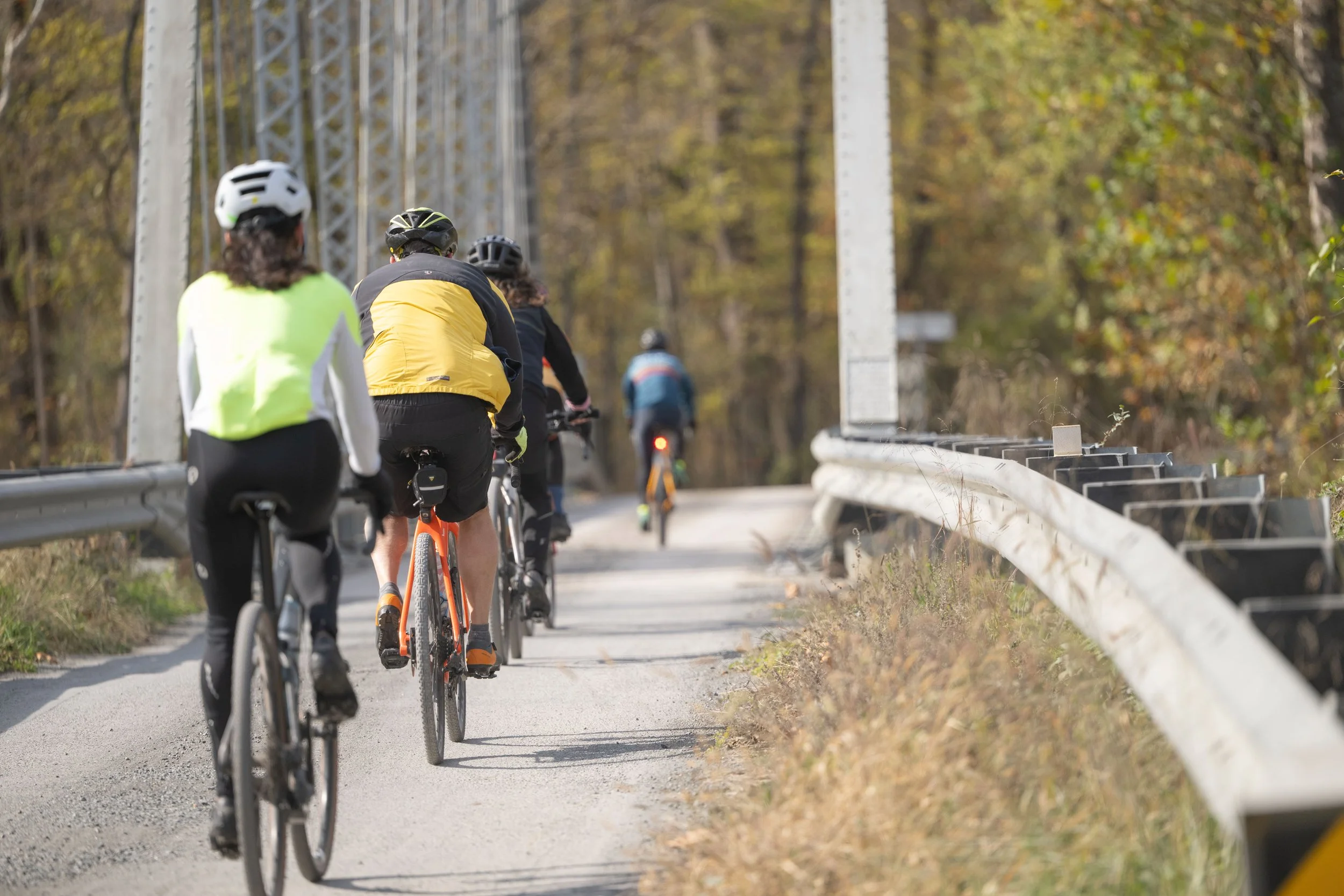 Gravel cyclists riding over the John Lewis bridge near Waterford, Va.