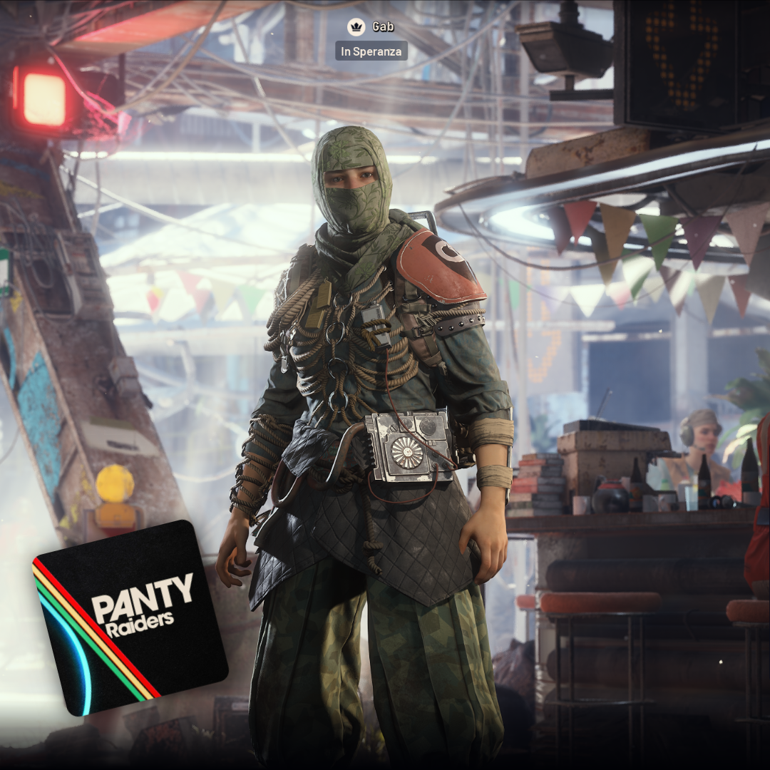 A person in a green ninja-style mask and tactical gear stands in an industrial bar looking at the camera.