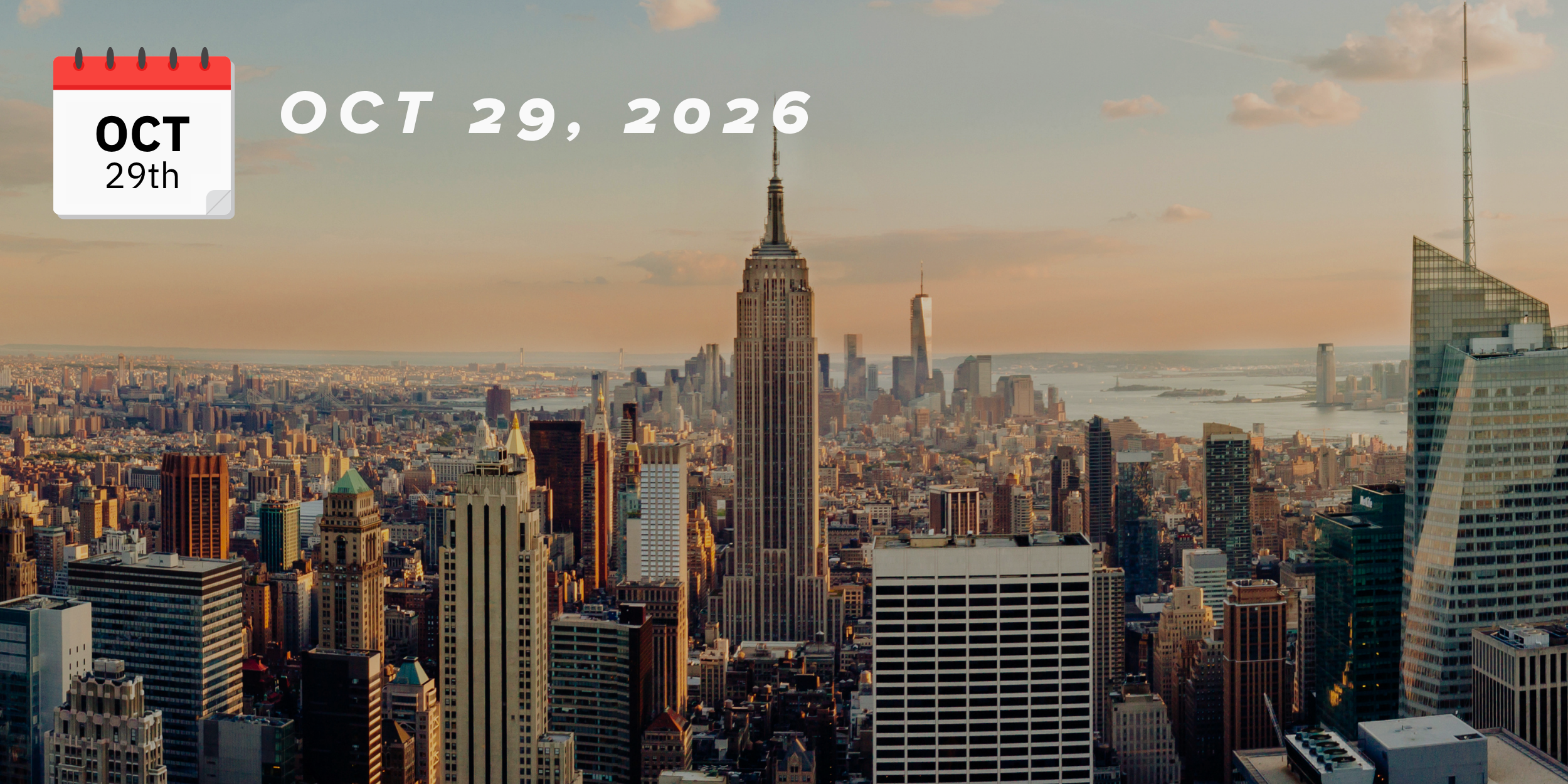 The skyline of New York City at sunset featuring the Empire State Building surrounded by other skyscrapers with a view of the river in the background.