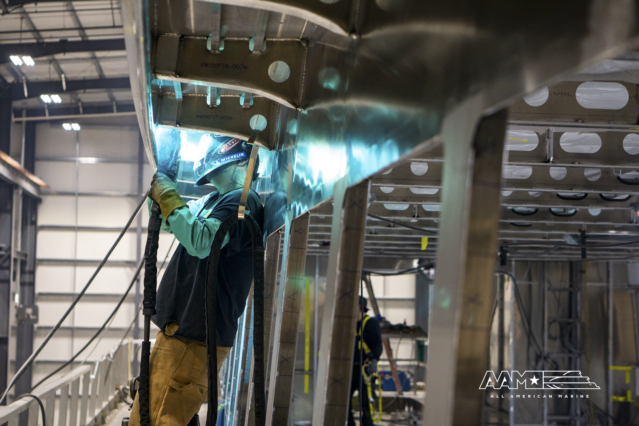 Welder working on aluminum boat