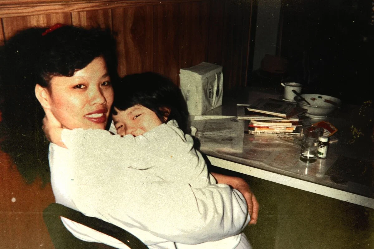 Rachel Phan, a five-year-old Chinese girl, tightly embraces her mother.