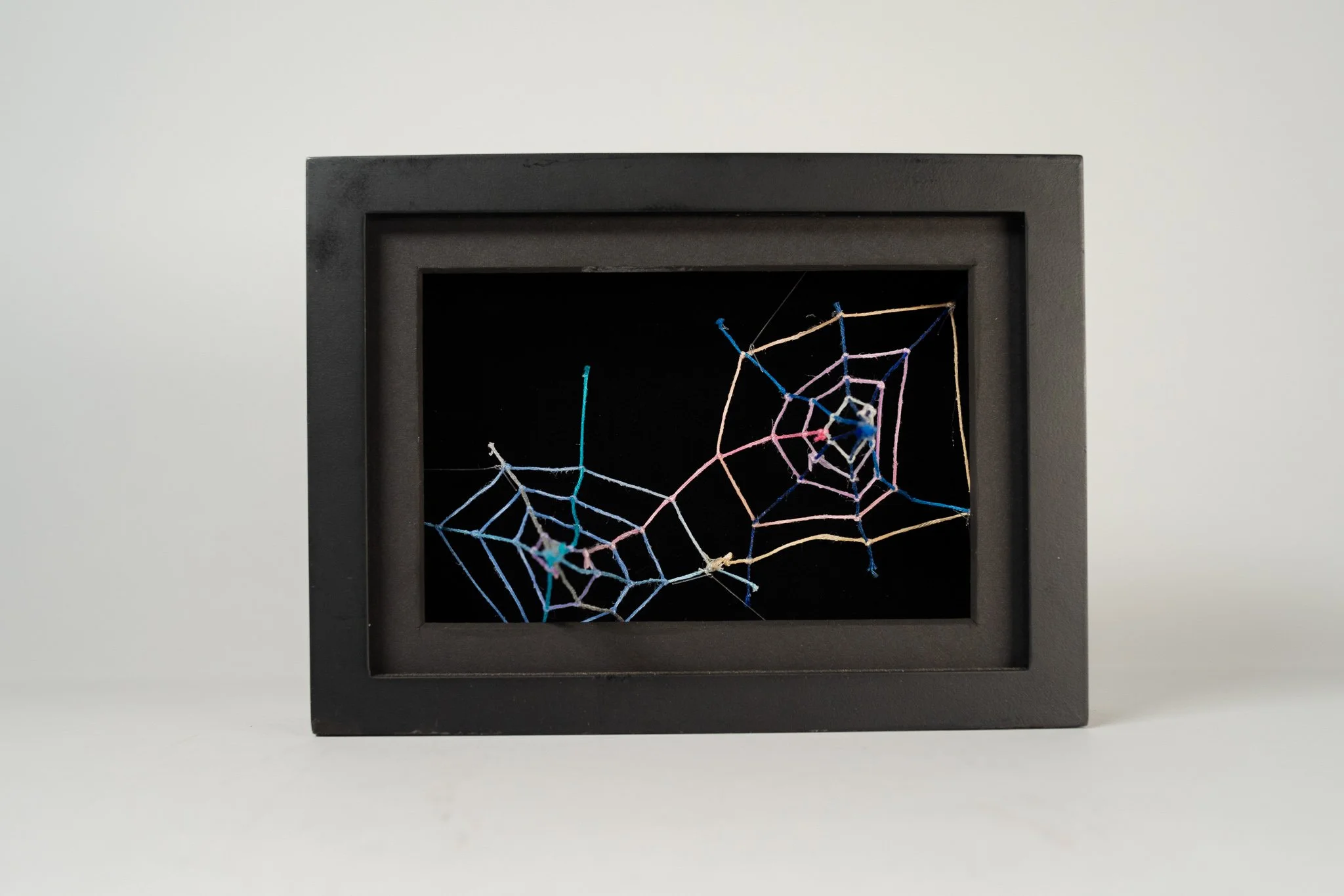 Underneath The Surface • Embroidery floss, clear cord, matted wood frame • 8 x 3.5 x 6 in • 2021