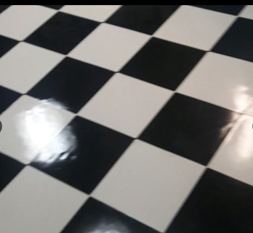 Black and white checkered tile floor with a glossy finish