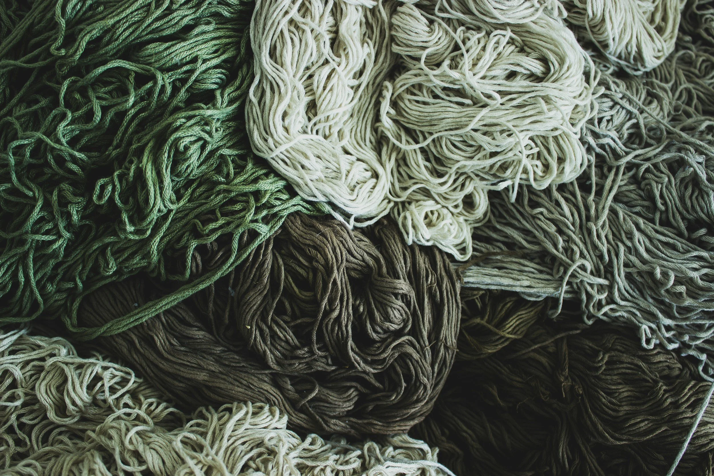 a pile of tangled yarn in shades of green