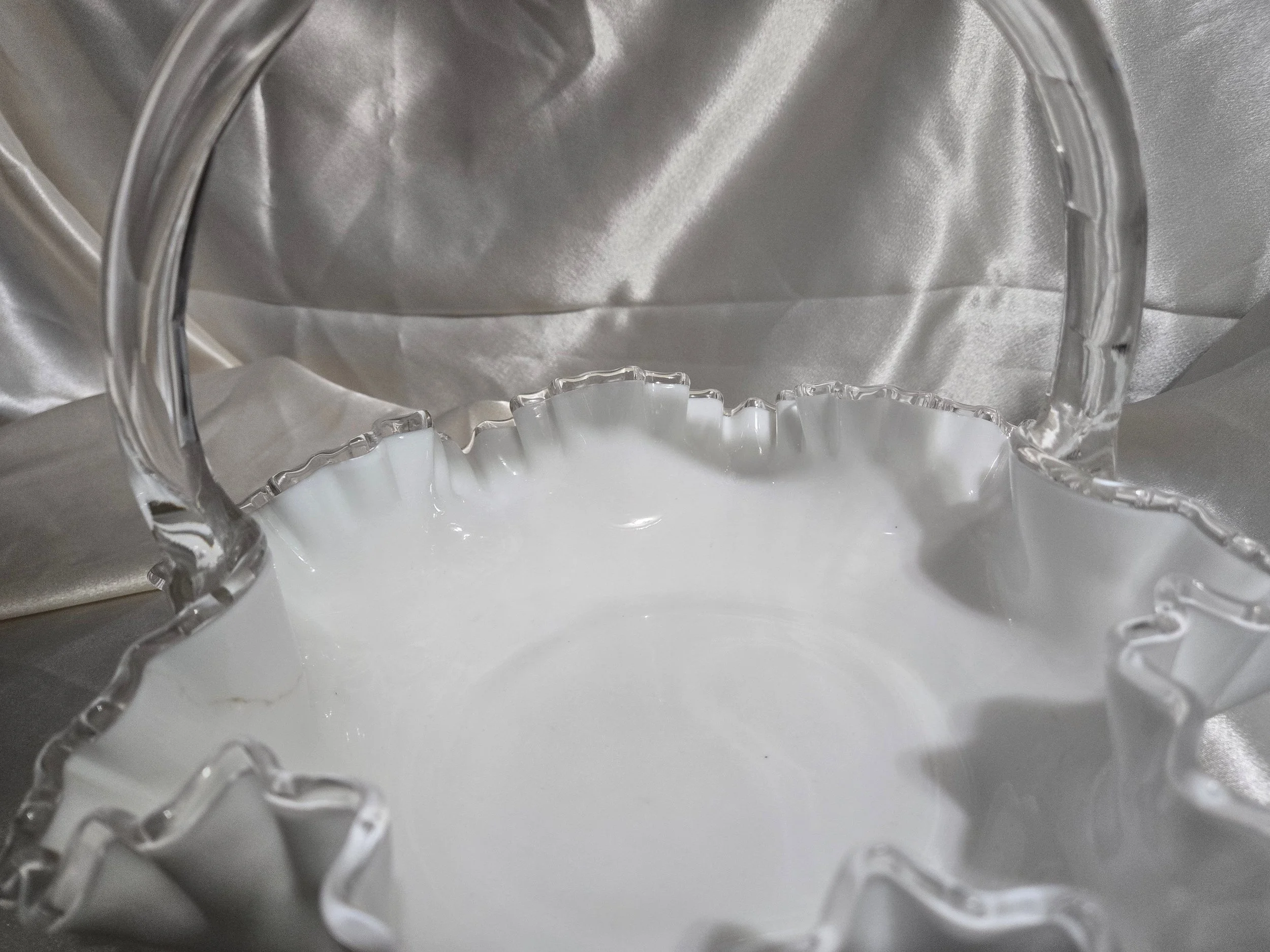 Vintage Fenton-style clear glass bowl featuring etched floral pattern and crown motif with visible handle repair.