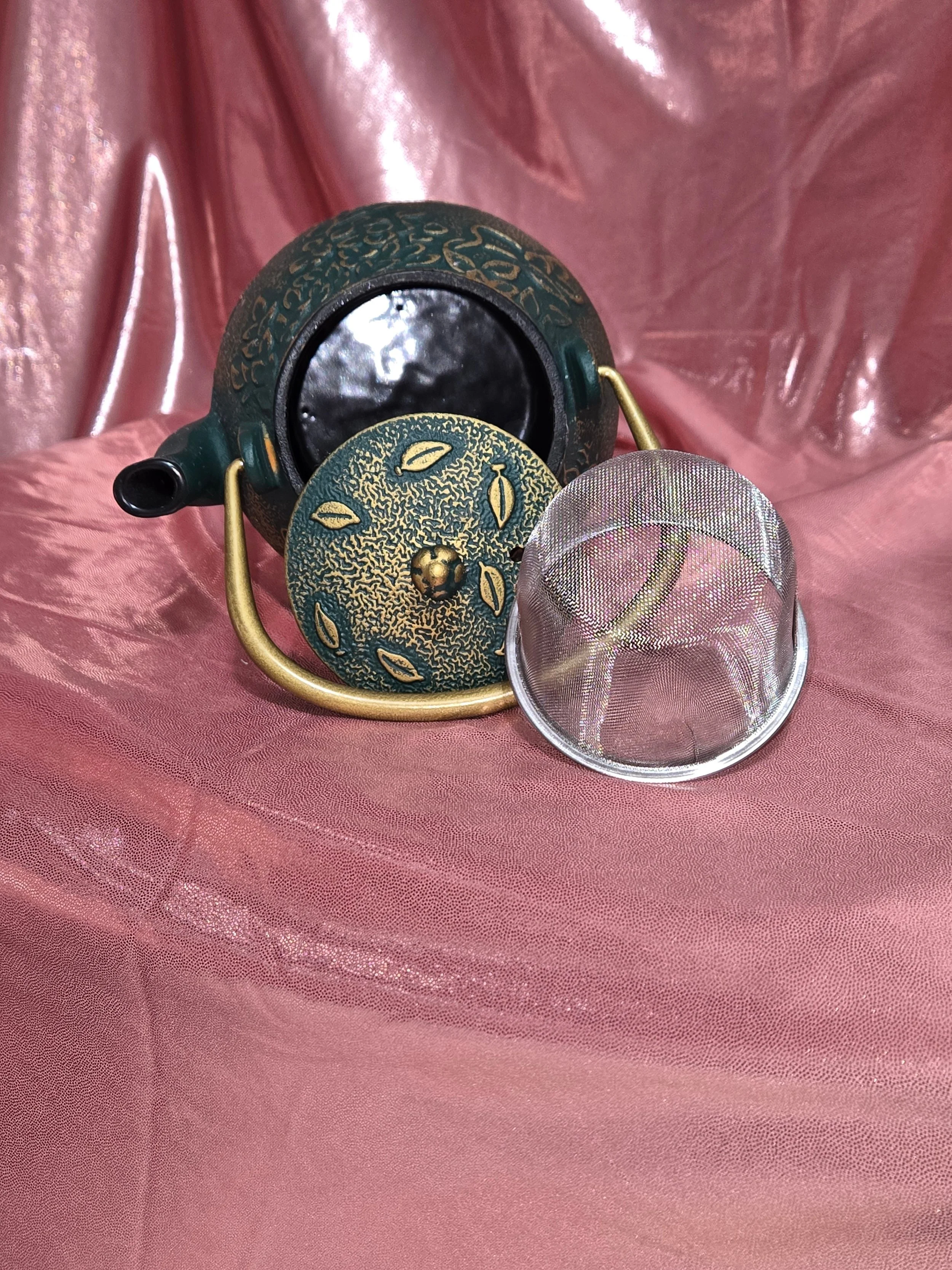 Green and gold cast iron teapot with infuser