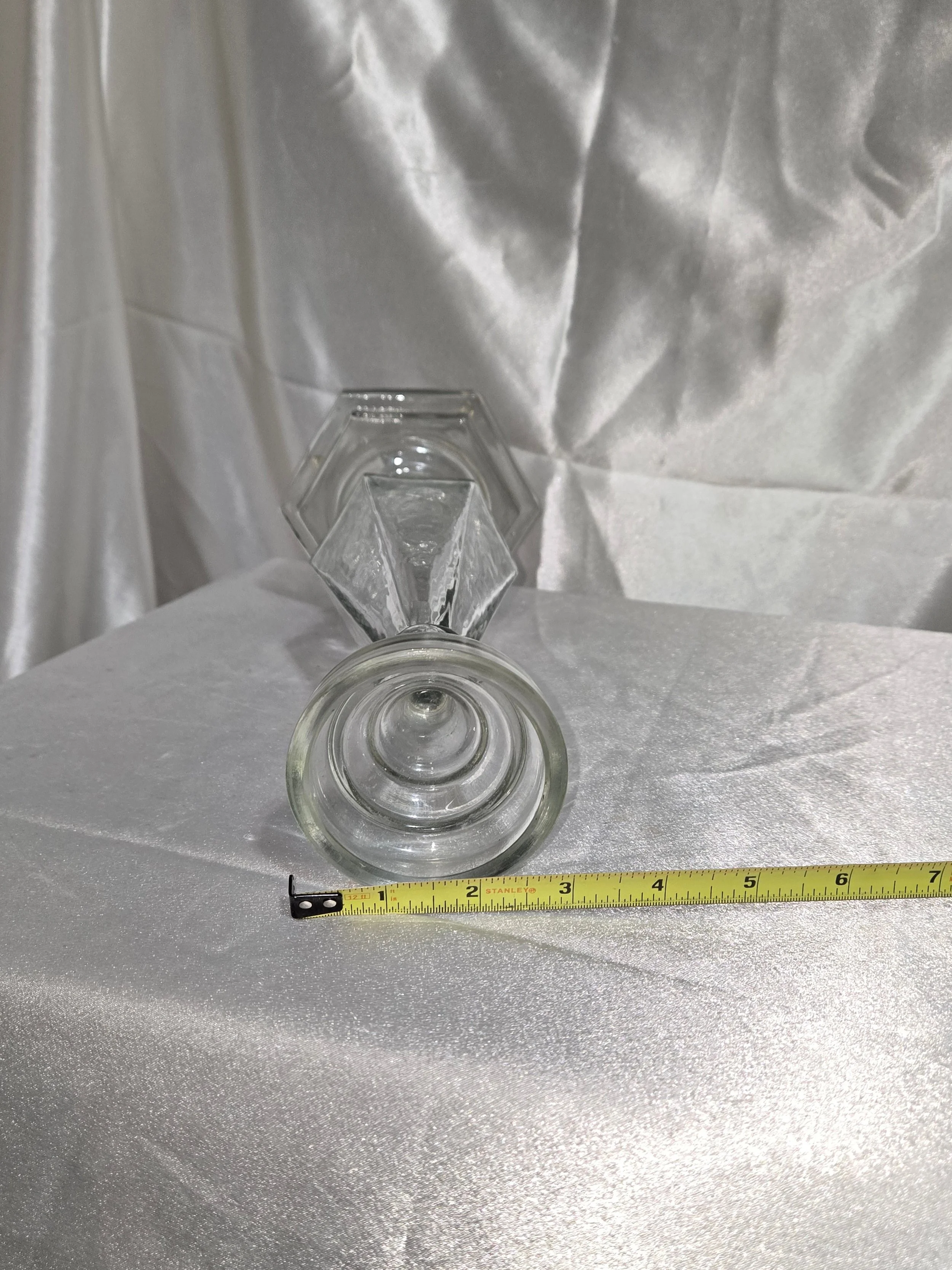 Vintage glass candlestick displayed on neutral background
