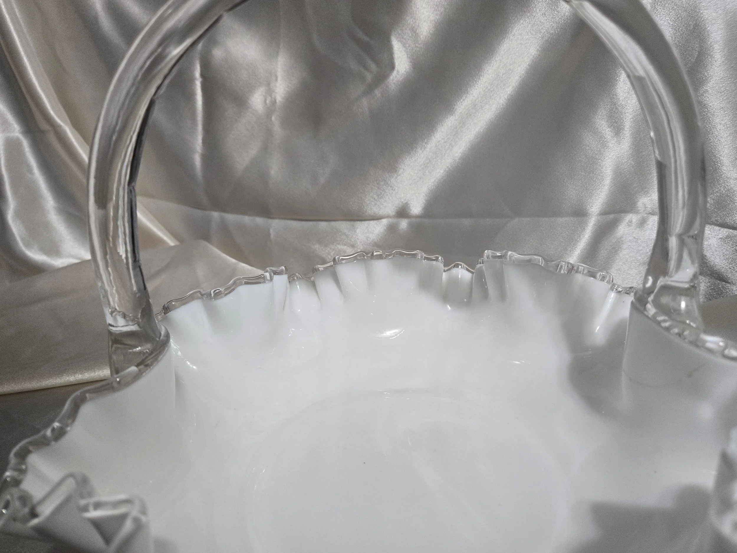 Vintage Fenton-style clear glass bowl featuring etched floral pattern and crown motif with visible handle repair.