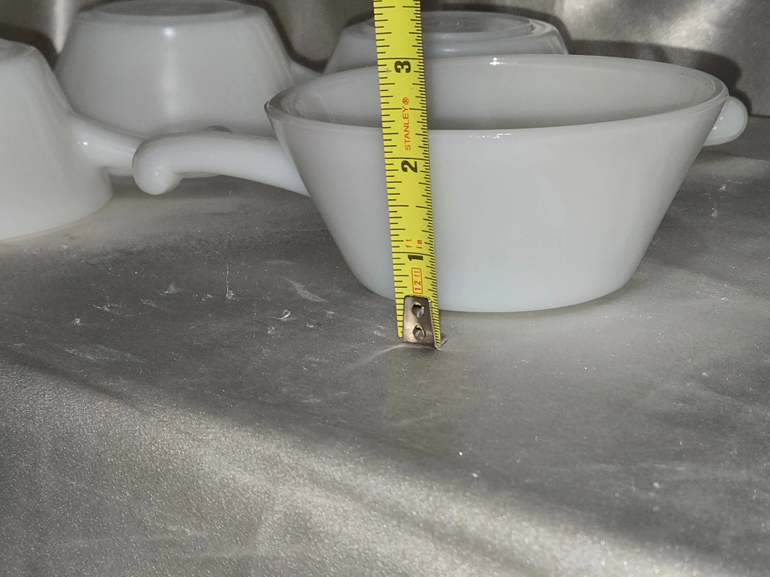 Close-up of vintage Fire-King milk glass soup bowl with handle, clean white glass and timeless design