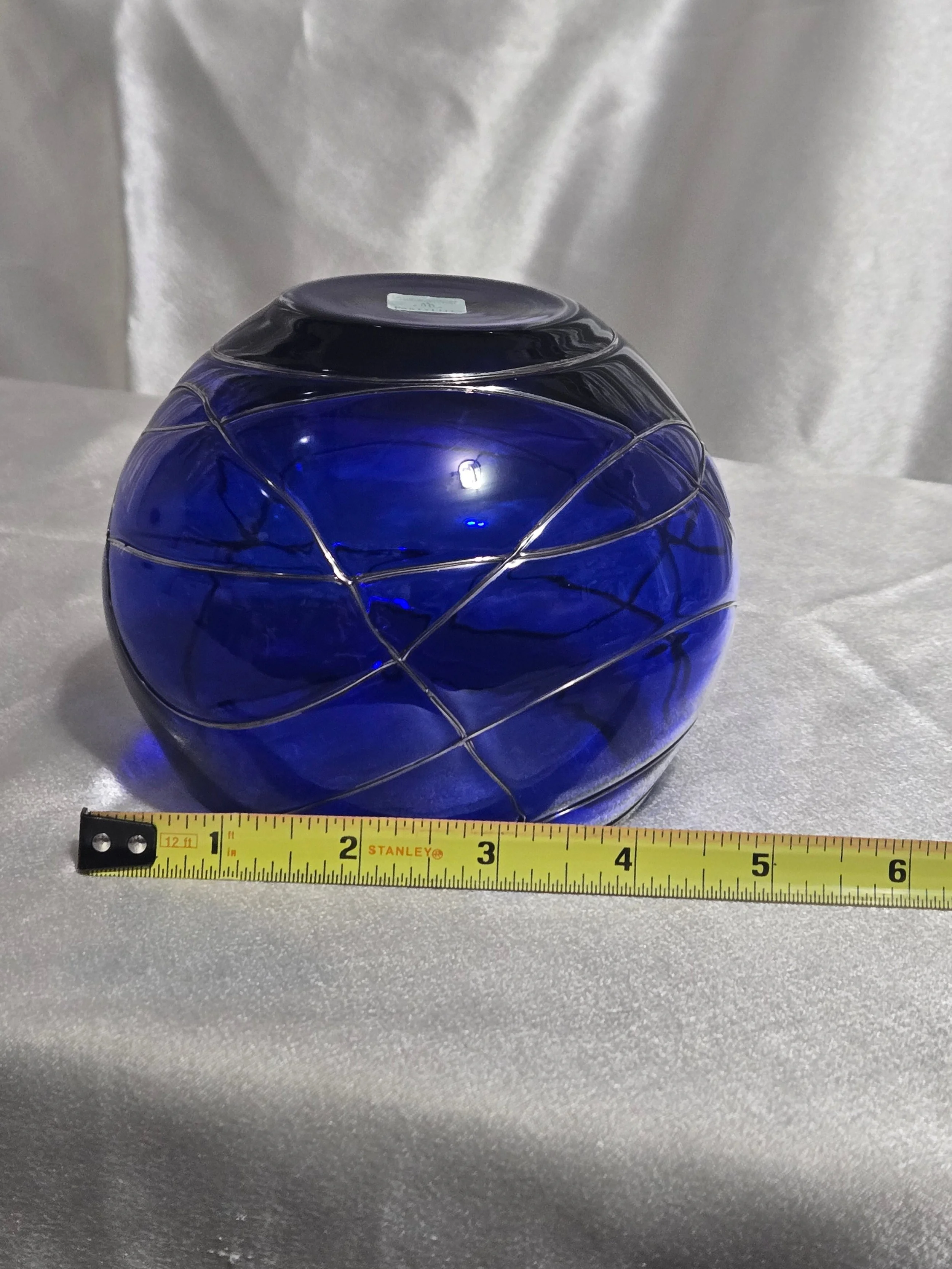 Cobalt blue hand-blown glass vase with silver swirl detailing, rounded art glass bowl, Murano-style decorative piece.
