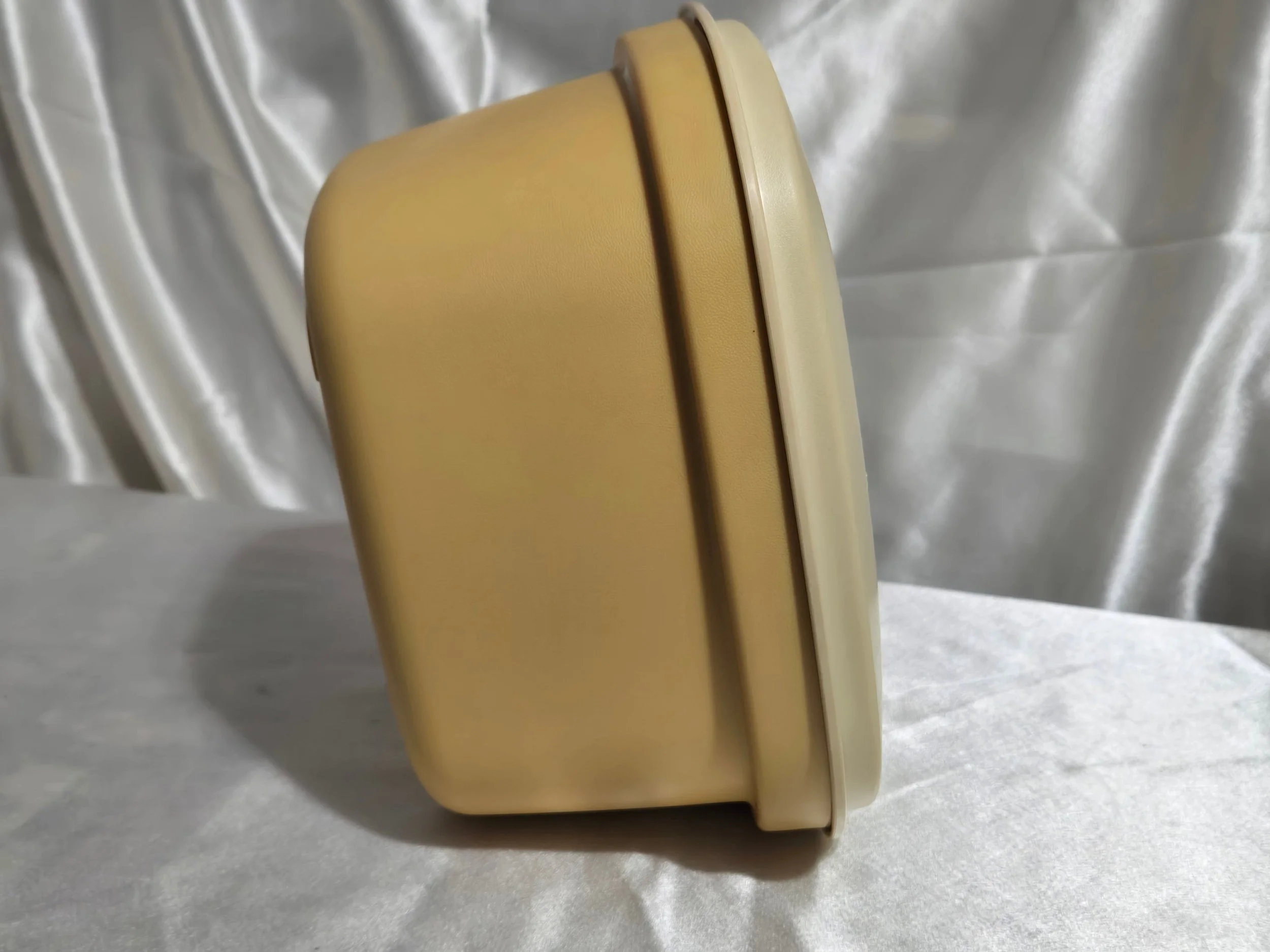 Vintage Tupperware microwave steamer in mustard yellow and ivory with lid, vented insert, and base shown together side view.