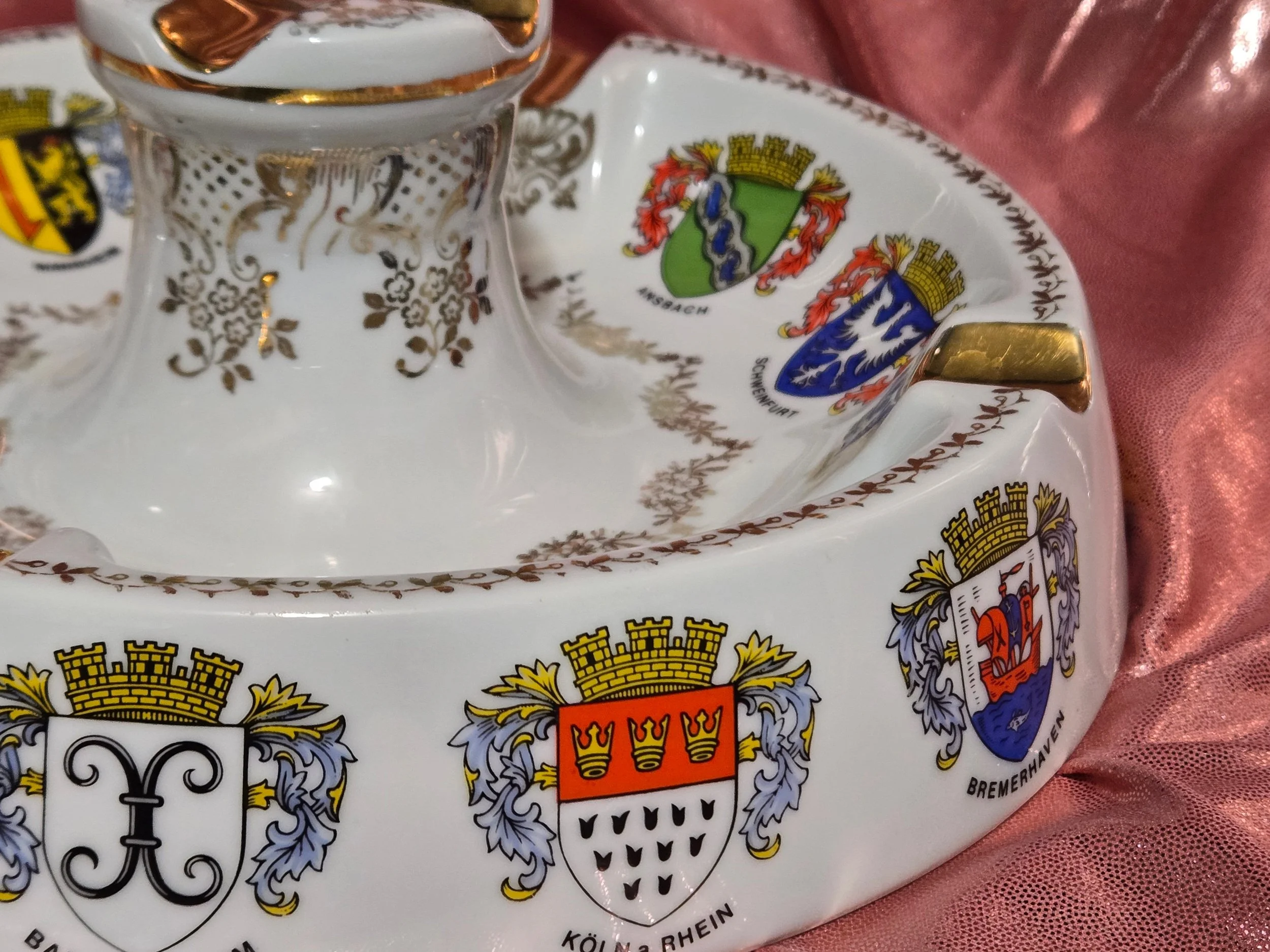 Detail of heraldic crests on porcelain ashtray