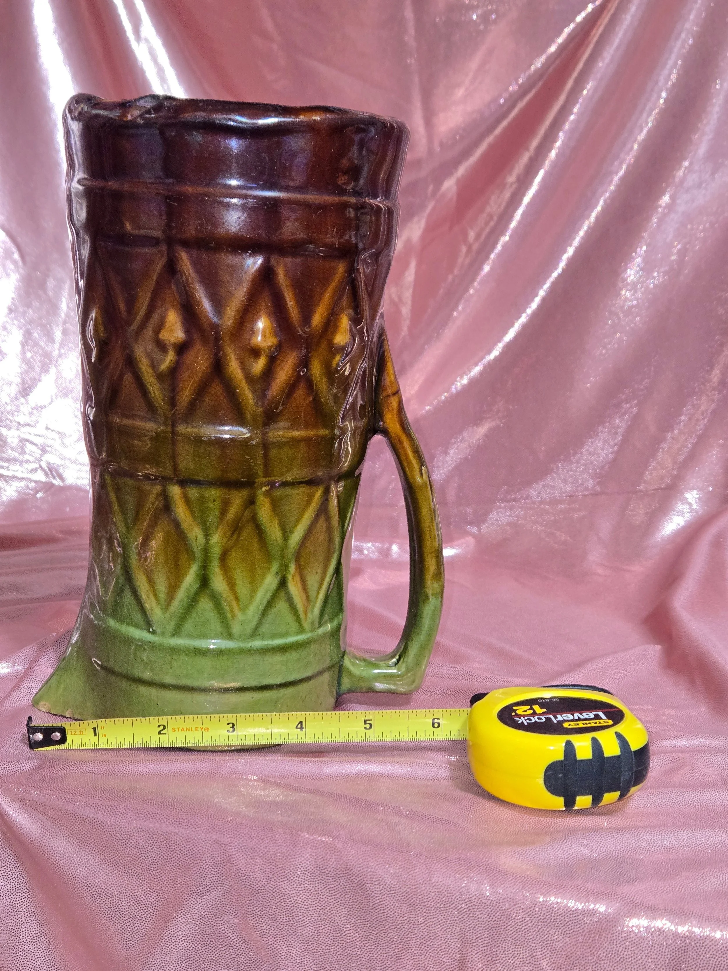 Side view of mid century pottery pitcher showing glaze detail