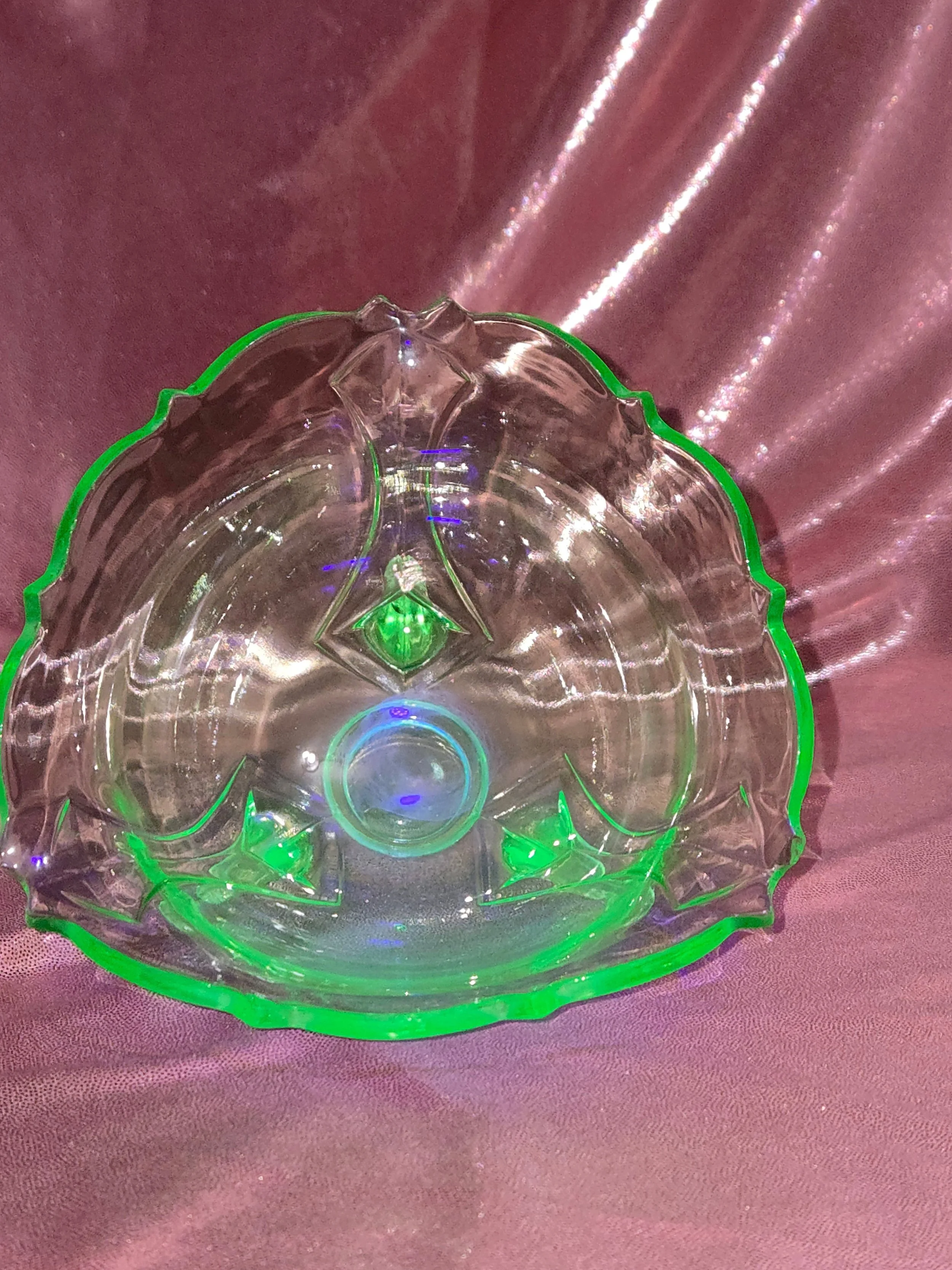 Vintage green uranium glass shell bowl glowing under UV light