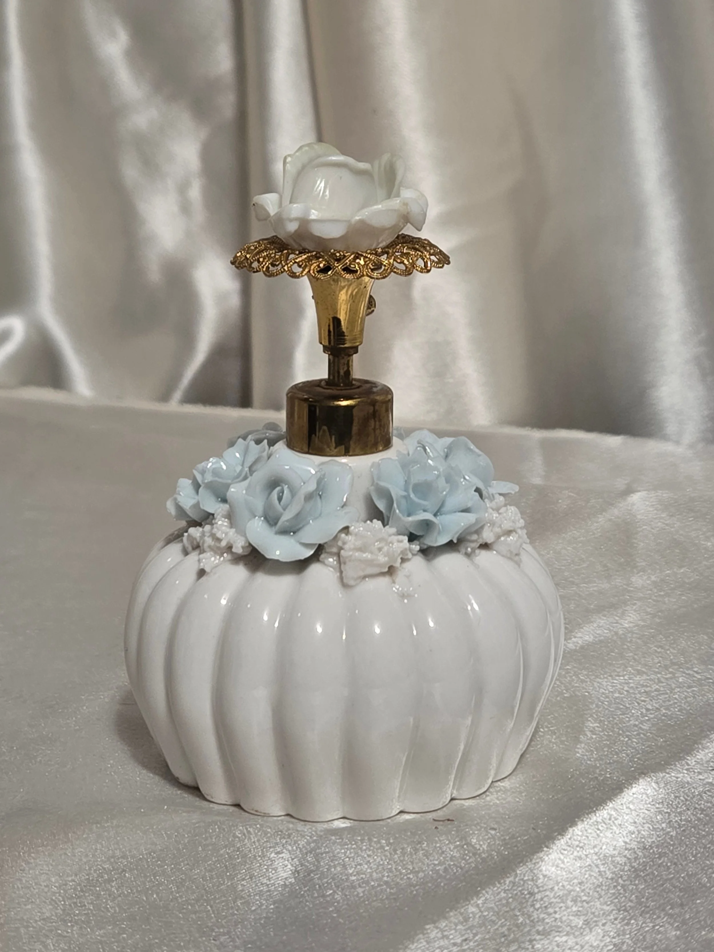 White ribbed perfume bottle with gold tone atomizer