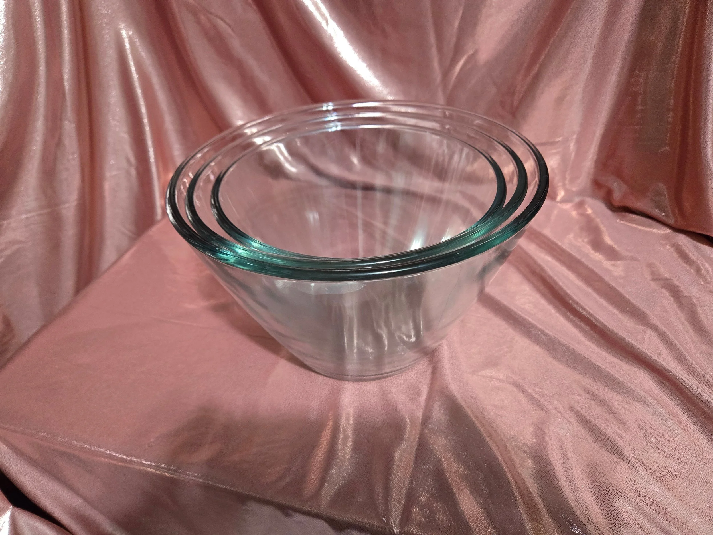 Three Anchor Hocking splash proof glass mixing bowls arranged to show nesting size comparison