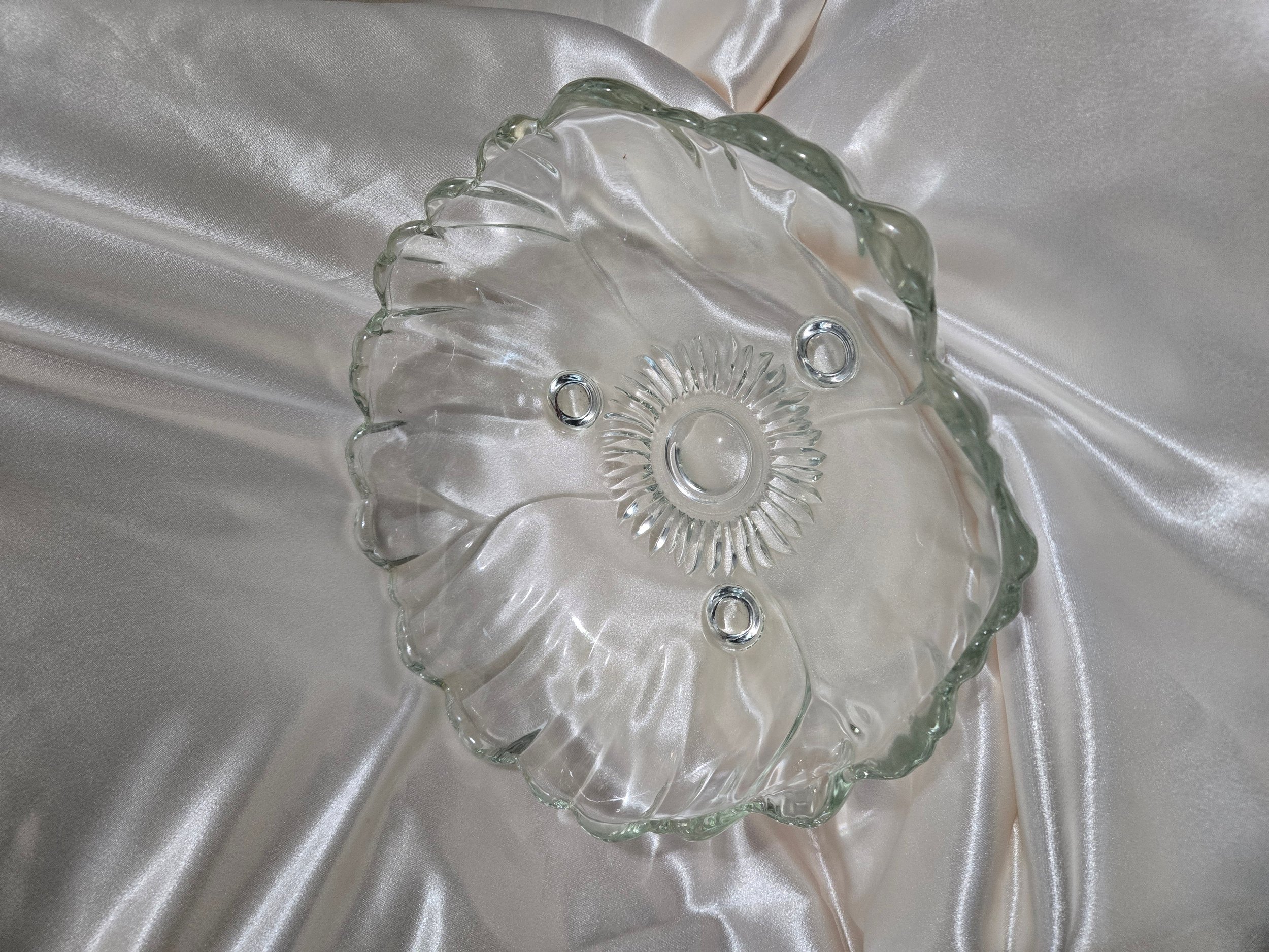 Top view of pressed sunflower design in clear glass