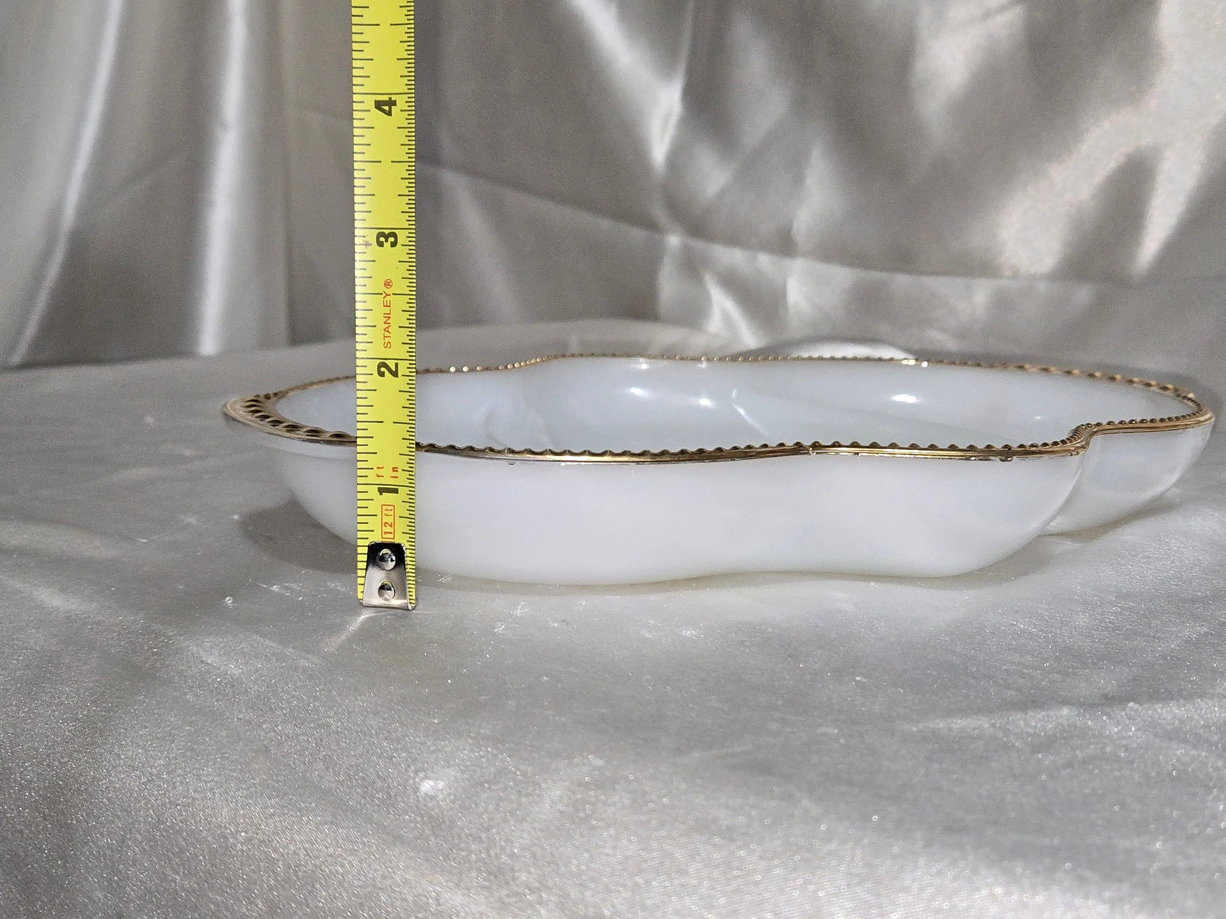 White Fire King relish tray with gold trim with measurement showing height