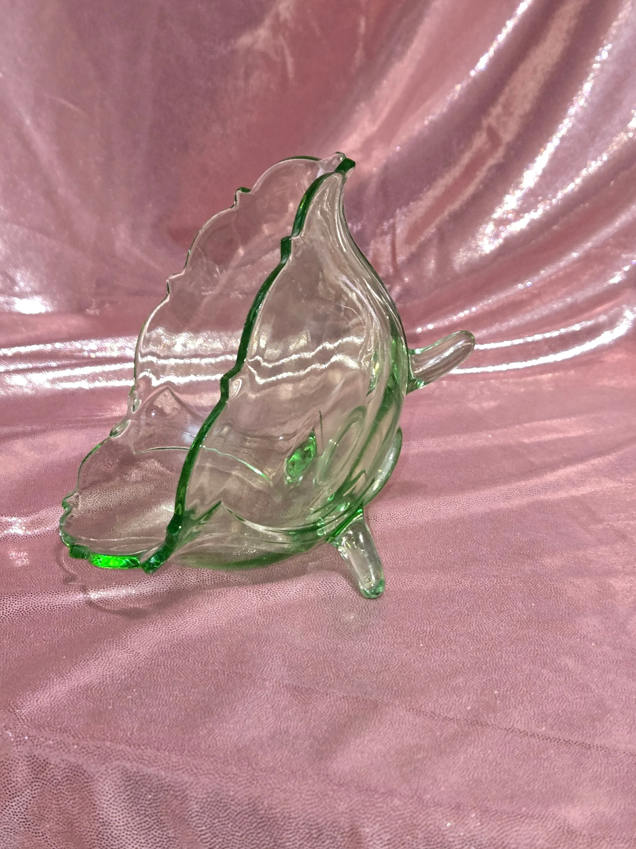 Side view of green uranium glass bowl showing scalloped rim