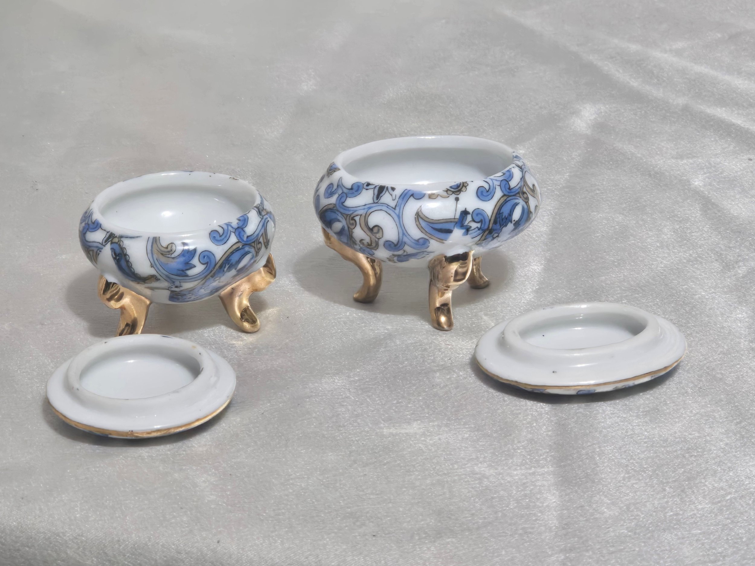 Vintage porcelain boxes displayed together