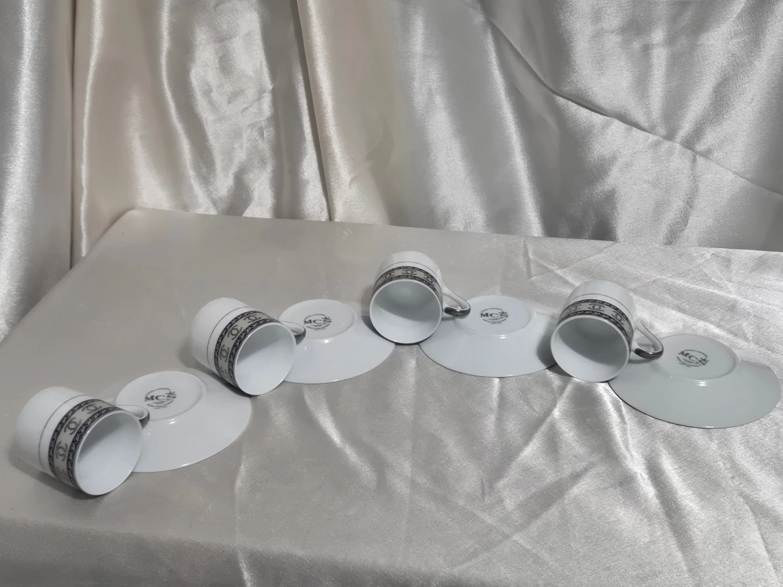 Set of 4 Mc Bavaria Espresso Demitasse Cups and Saucers cups on their sudes and the saucers turned over showing you the plate bottom