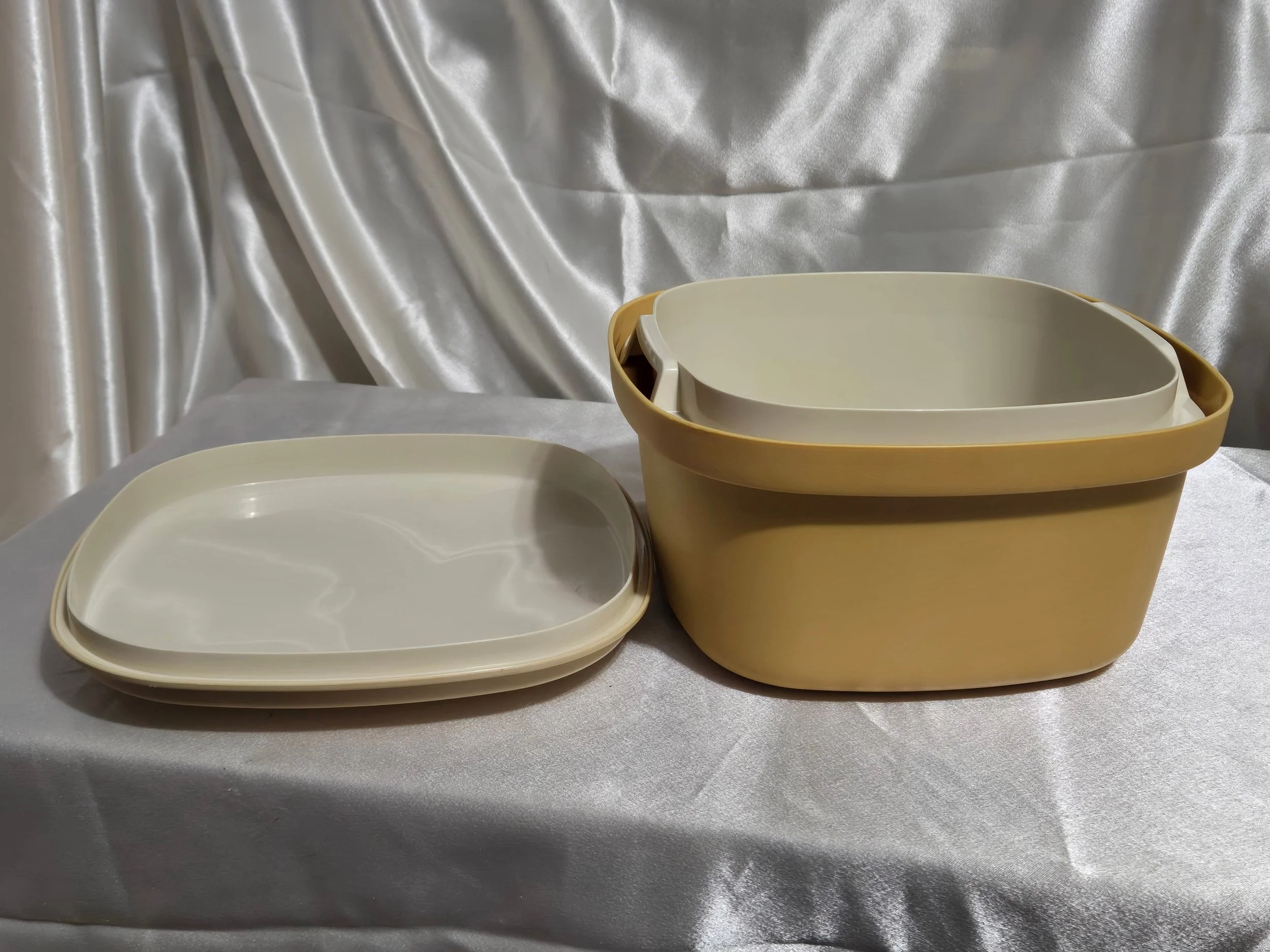 Vintage Tupperware microwave steamer in mustard yellow and ivory with lid, vented insert, and base shown together.