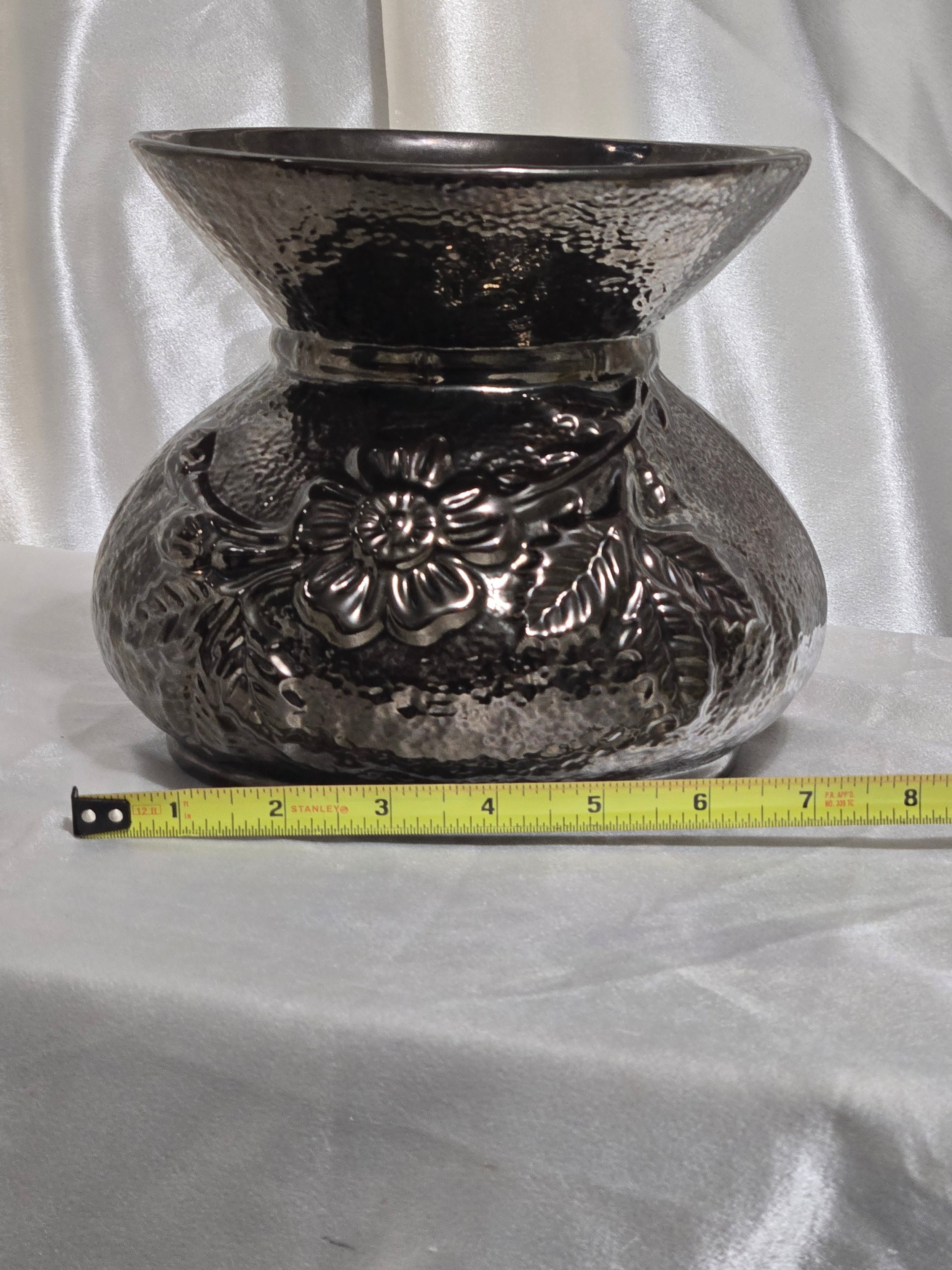 Sculptural black ceramic vase with raised floral relief
