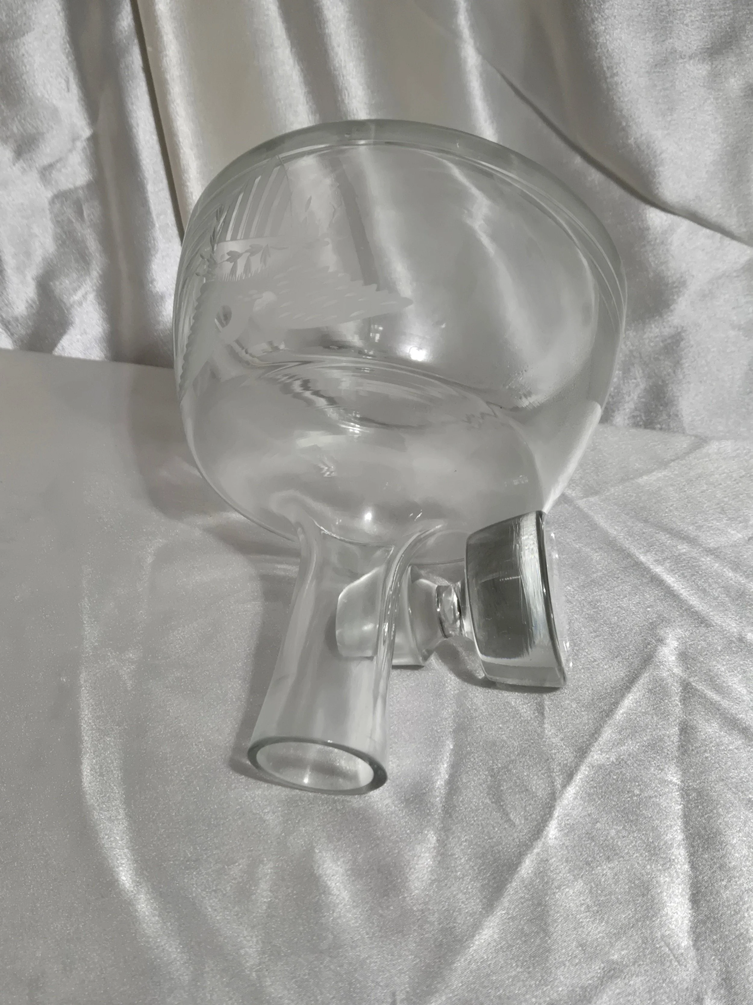 Side view of clear glass decanter highlighting curved body and tall tapered neck