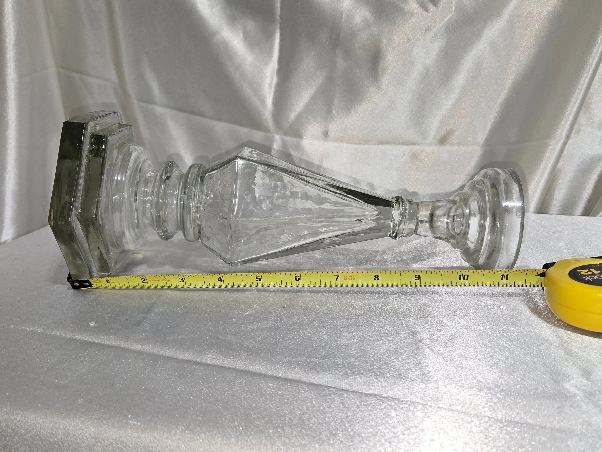 Side view of glass candlestick showing faceted details