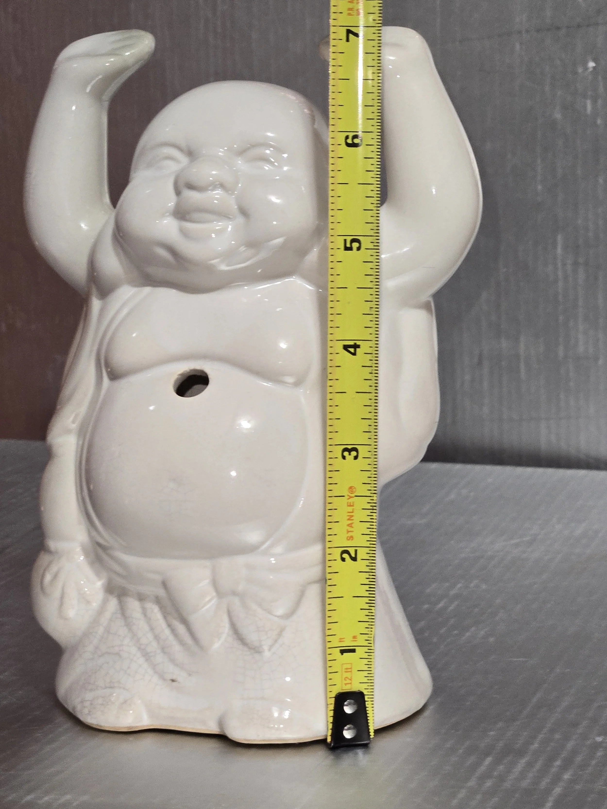 Buddha statue with measuring tape showing height