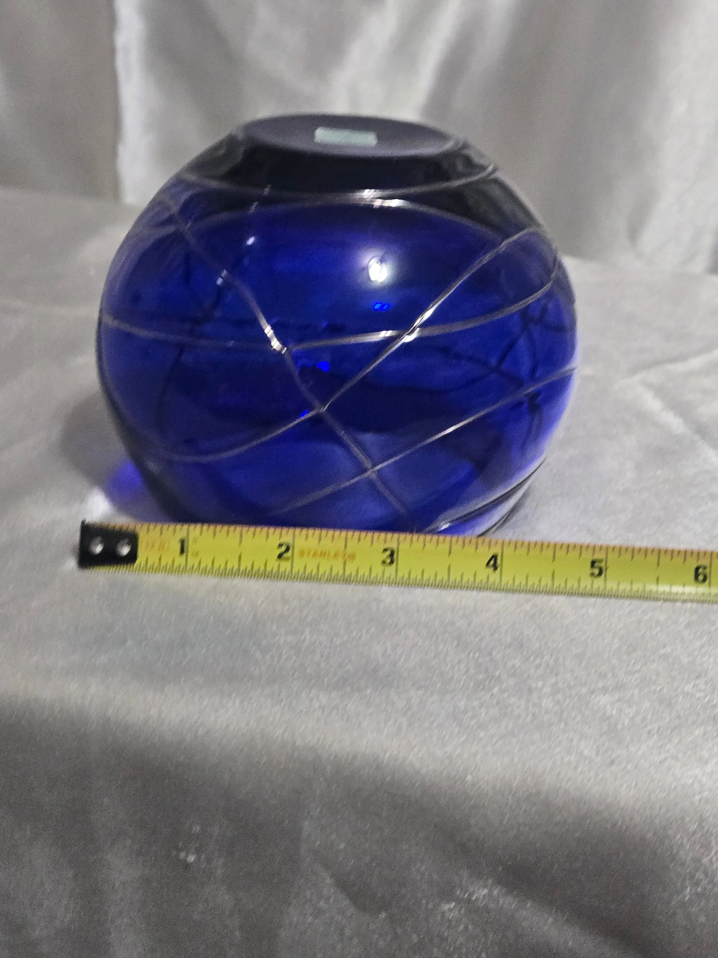 Cobalt blue hand-blown glass vase with silver swirl detailing, rounded art glass bowl, Murano-style decorative piece.