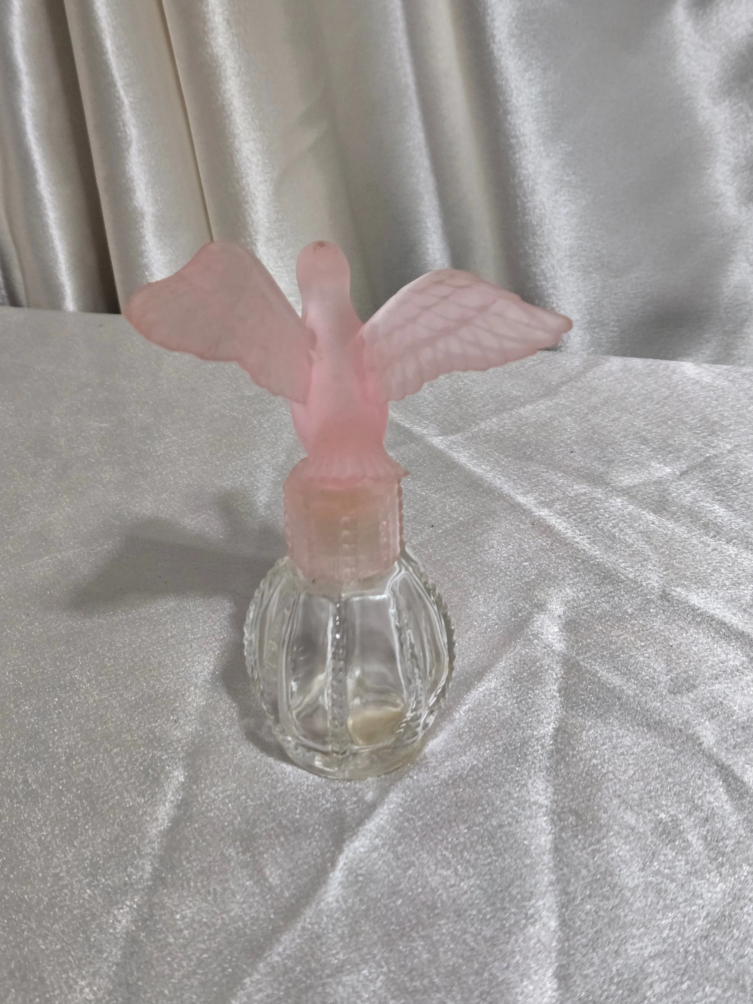 Front view of vintage Avon pink frosted dove perfume bottle from the 1980s