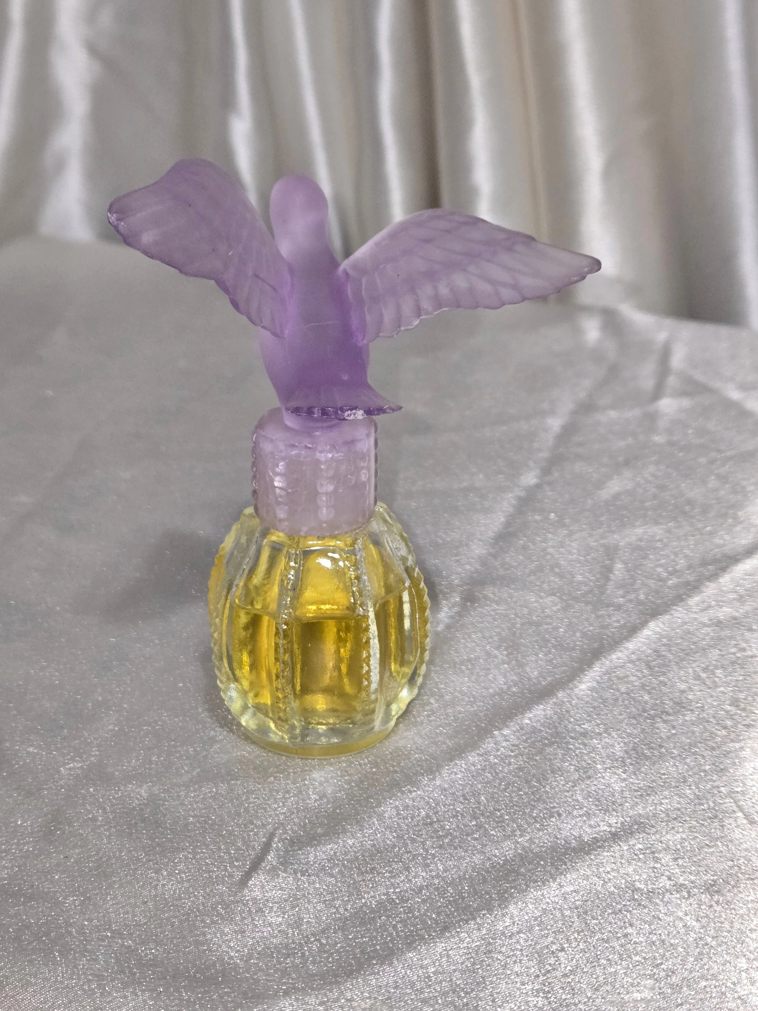 Front view of vintage Avon purple frosted dove perfume bottle from the 1980s.