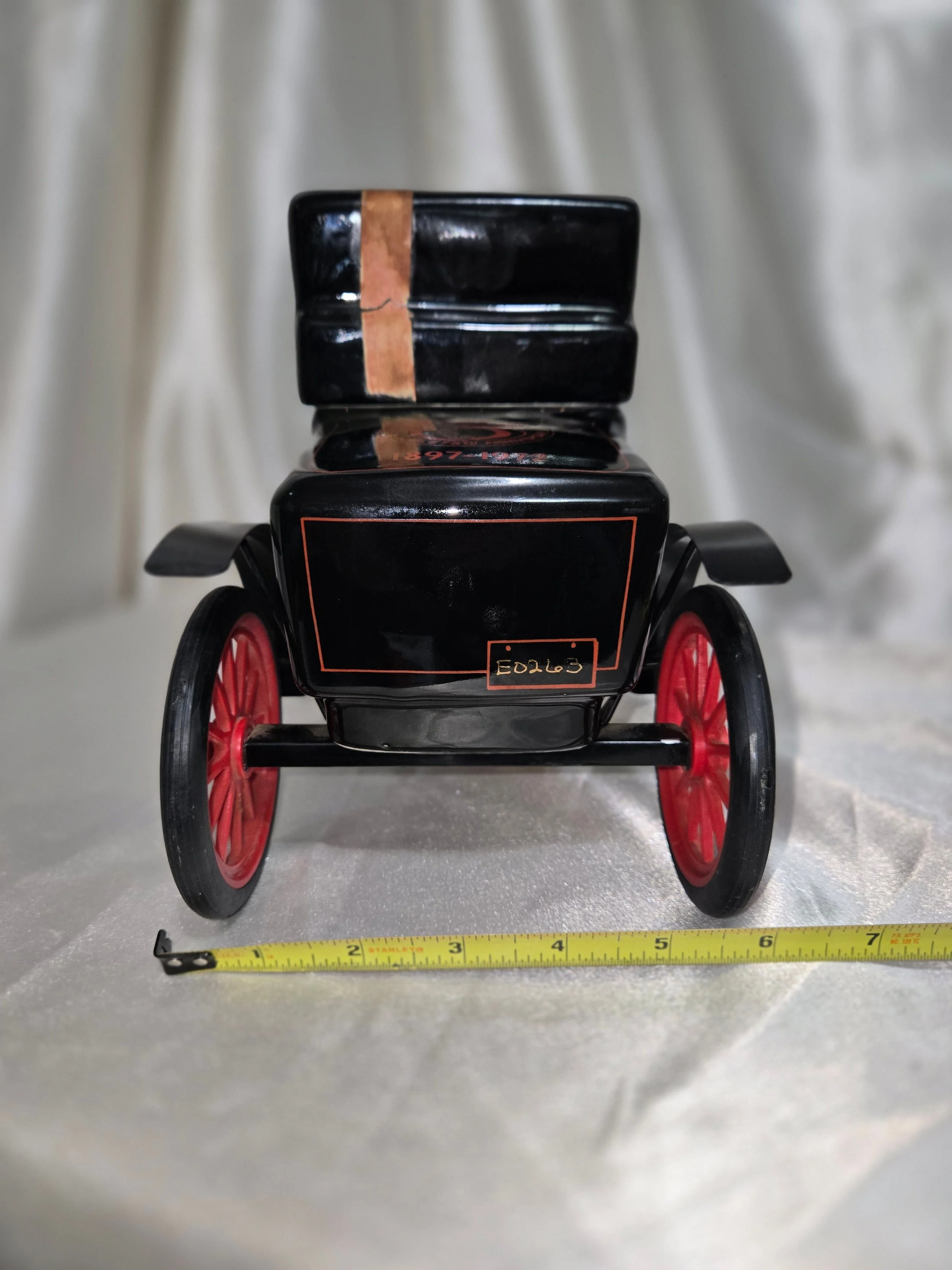 Rear view of black Jim Beam whiskey decanter showing molded ceramic body