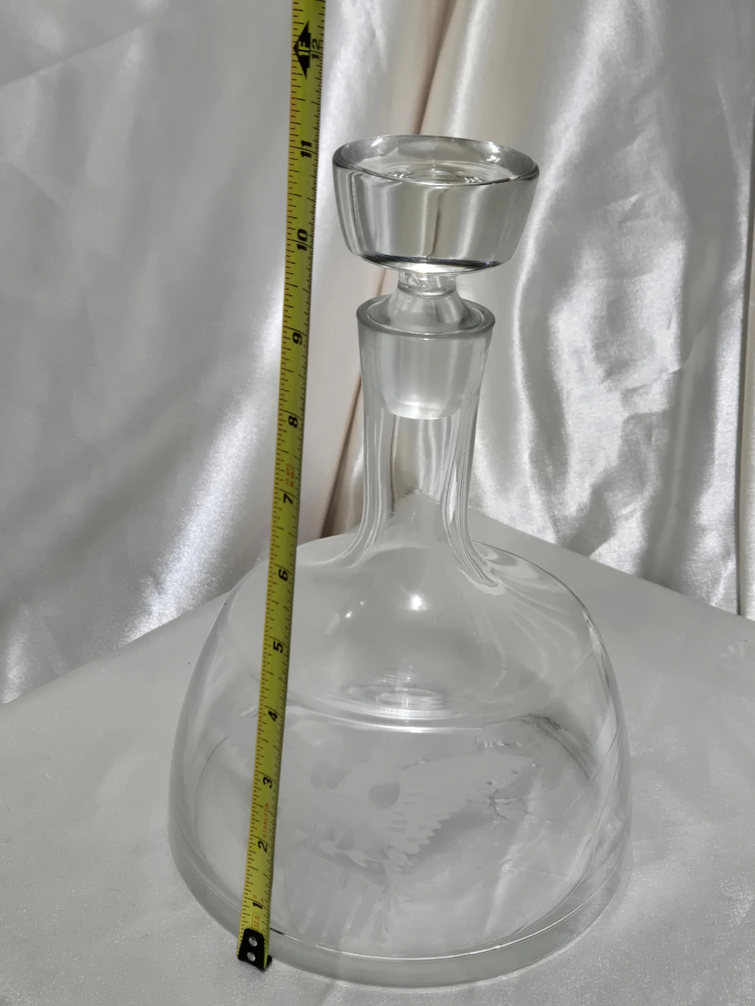 Glass decanter shown with measuring tape to display approximate height and base width