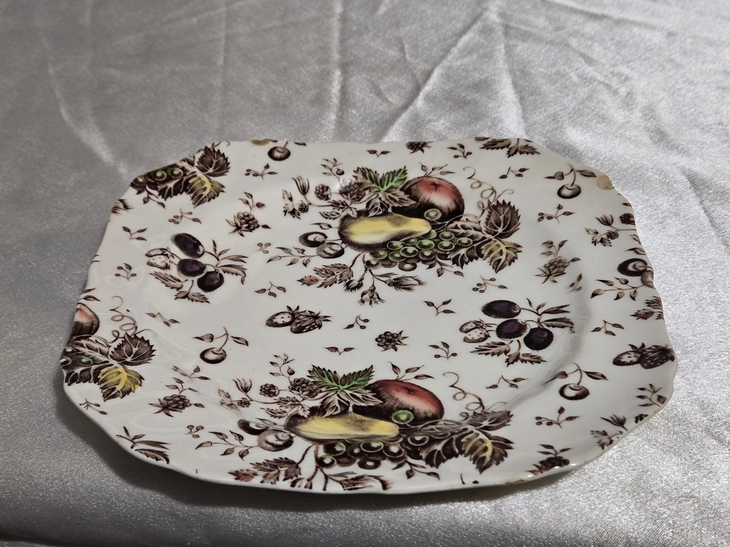 Vintage Autumn’s Delight floral dish with warm orange and gold tones, embossed leaf pattern, and scalloped edges on display.